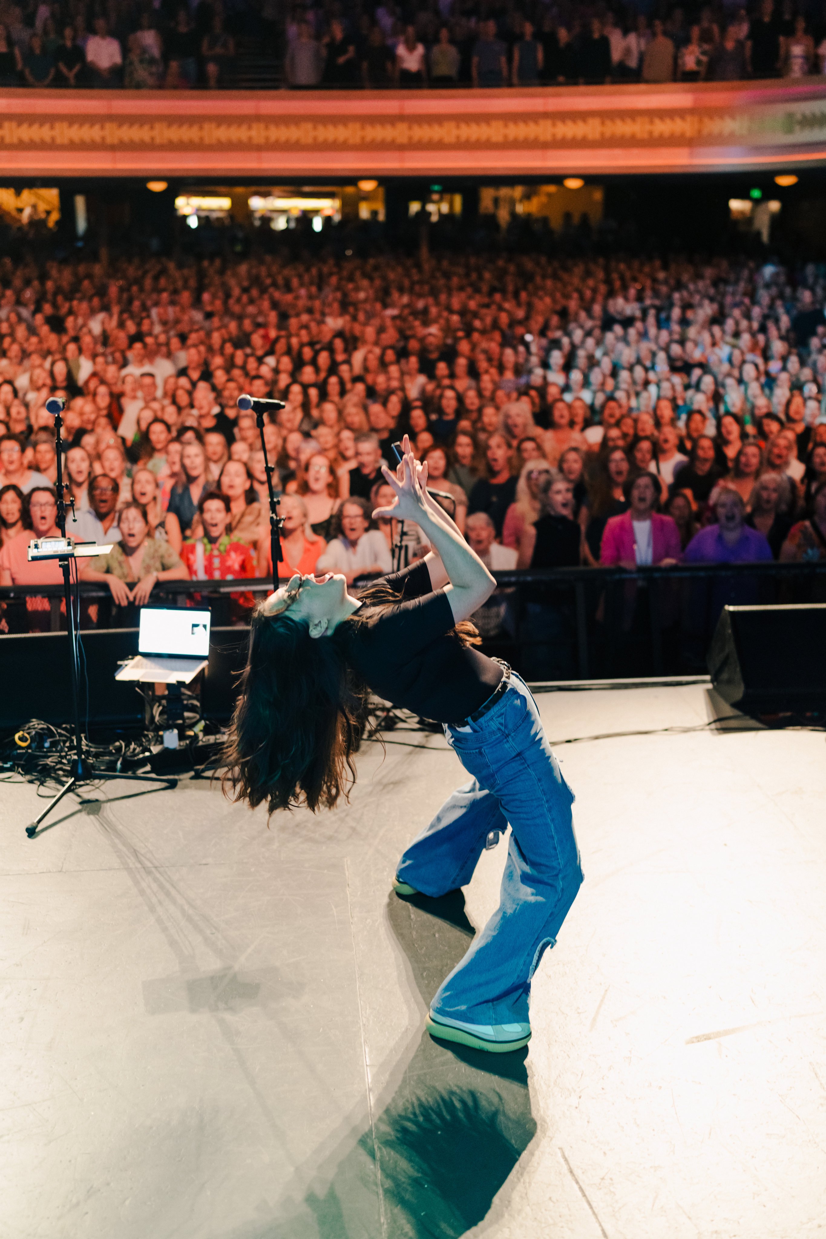 Australian vocalist and conductor Astrid Jorgensen on stage at an energetic Pub Choir performance. Photo: Pub Choir