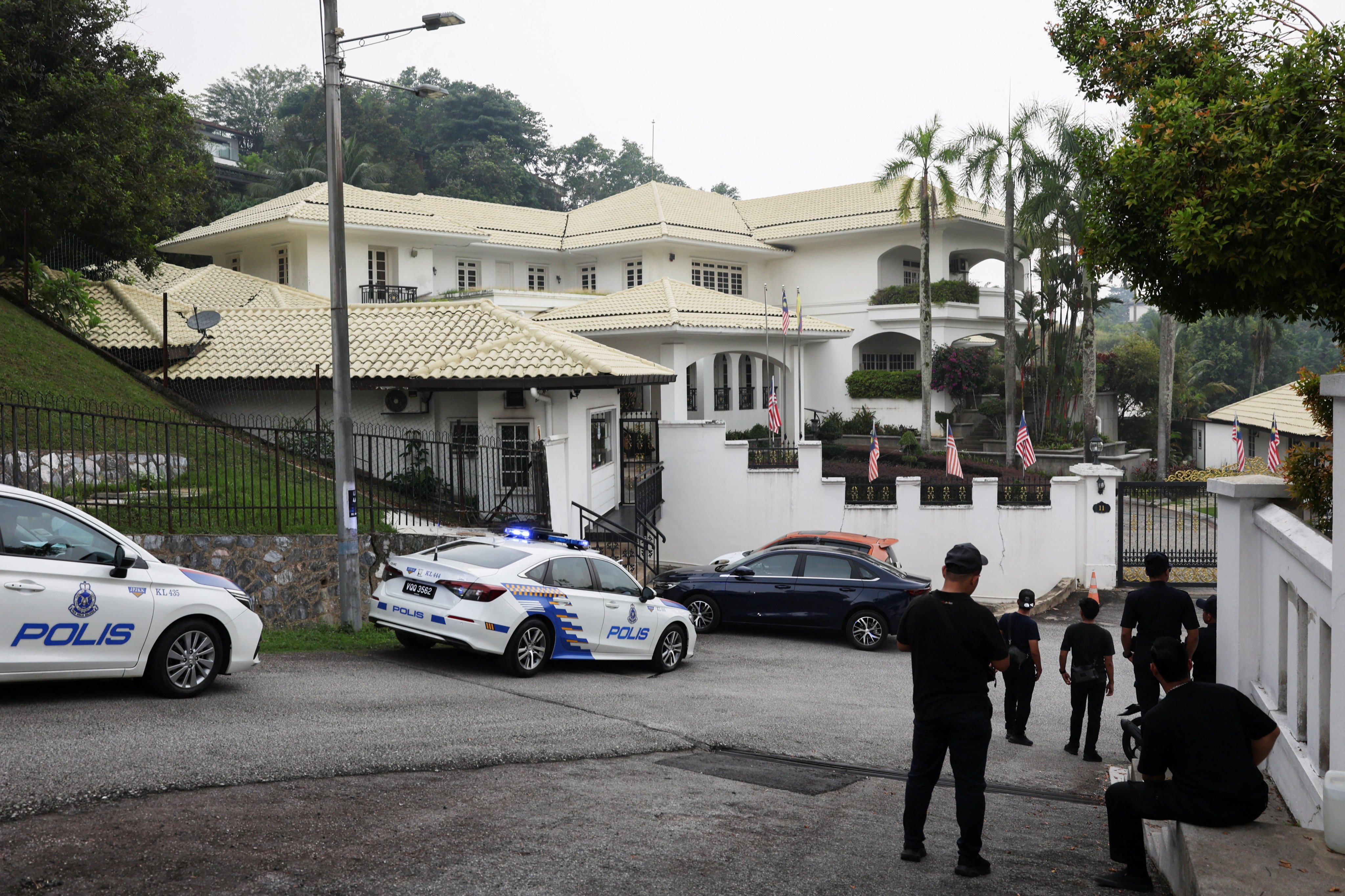 Police patrol cars are parked outside Najib Razak’s house in Kuala Lumpur on Friday. Photo: Reuters