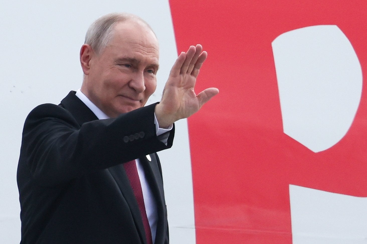 Russian President Vladimir Putin waves while boarding a plane upon his departure from India on September 13. Photo: Kremlin/Sputnik/EPA