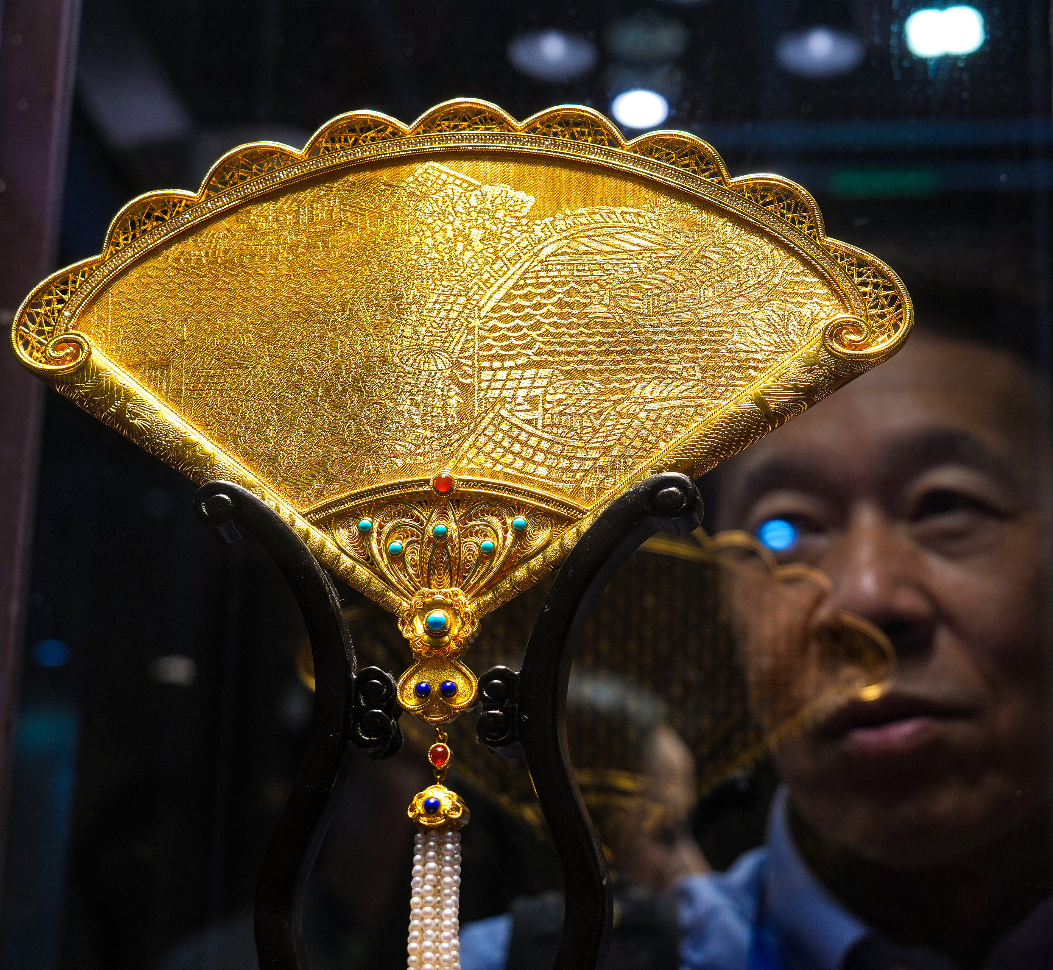 A pure gold decorative fan ornament, is displayed at the Jewellery & Gem World Hong Kong fair at Hong Kong Convention and Exhibition Centre on Wednesday. Photo: Kit Lai