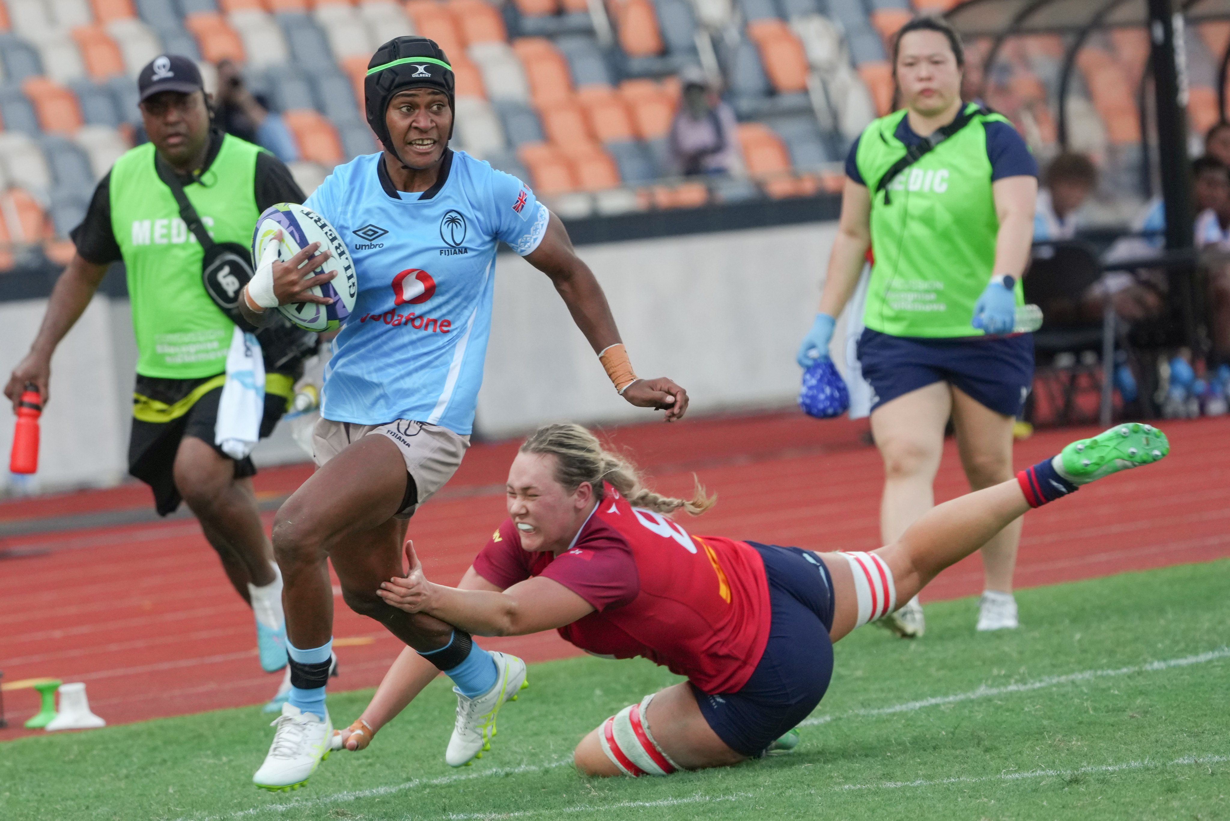 Fiji winger Atelaite Buna (left) evades the tackle of Hong Kong No 8 Grace Hood in her team's 54-26 win at Kai Tak Youth Sports Ground on Saturday. Photo: Dickson Lee