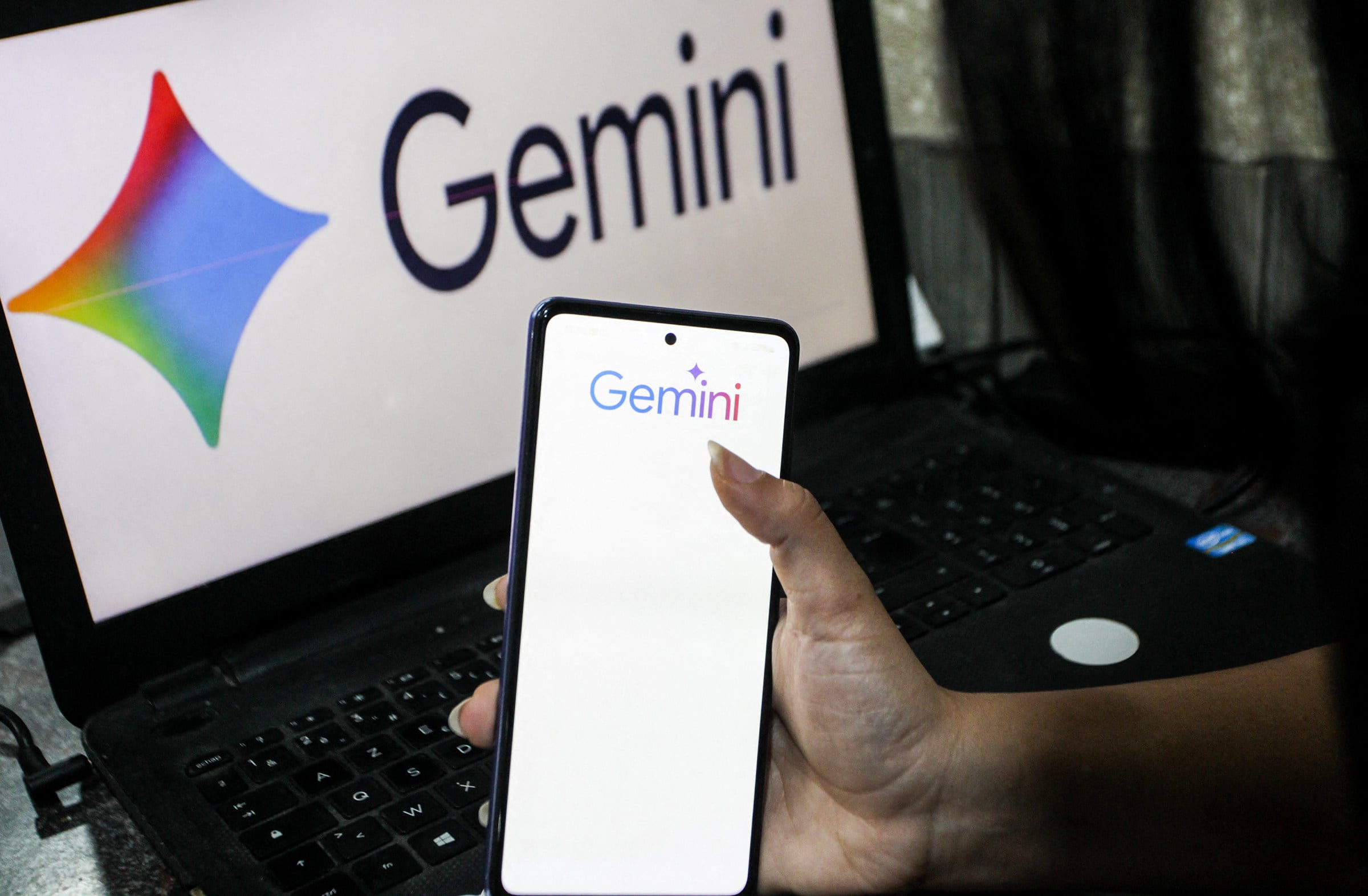Google Gemini logos are displayed on a smartphone and computer screen. Photo: TNS