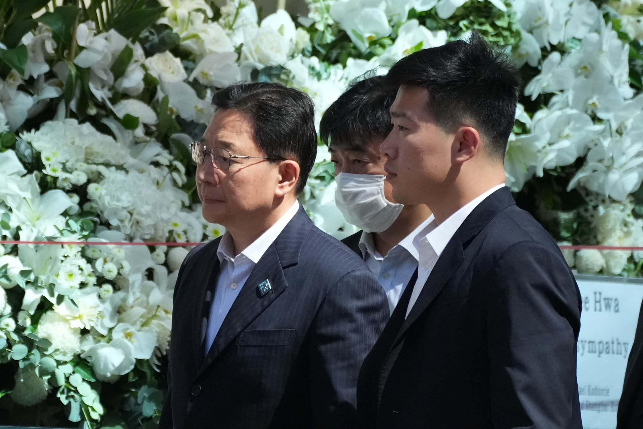 Zhou Ji (left), director of Beijing’s liaison office in Hong Kong, arrives at Hong Kong Funeral Home. Photo: Kit Lai