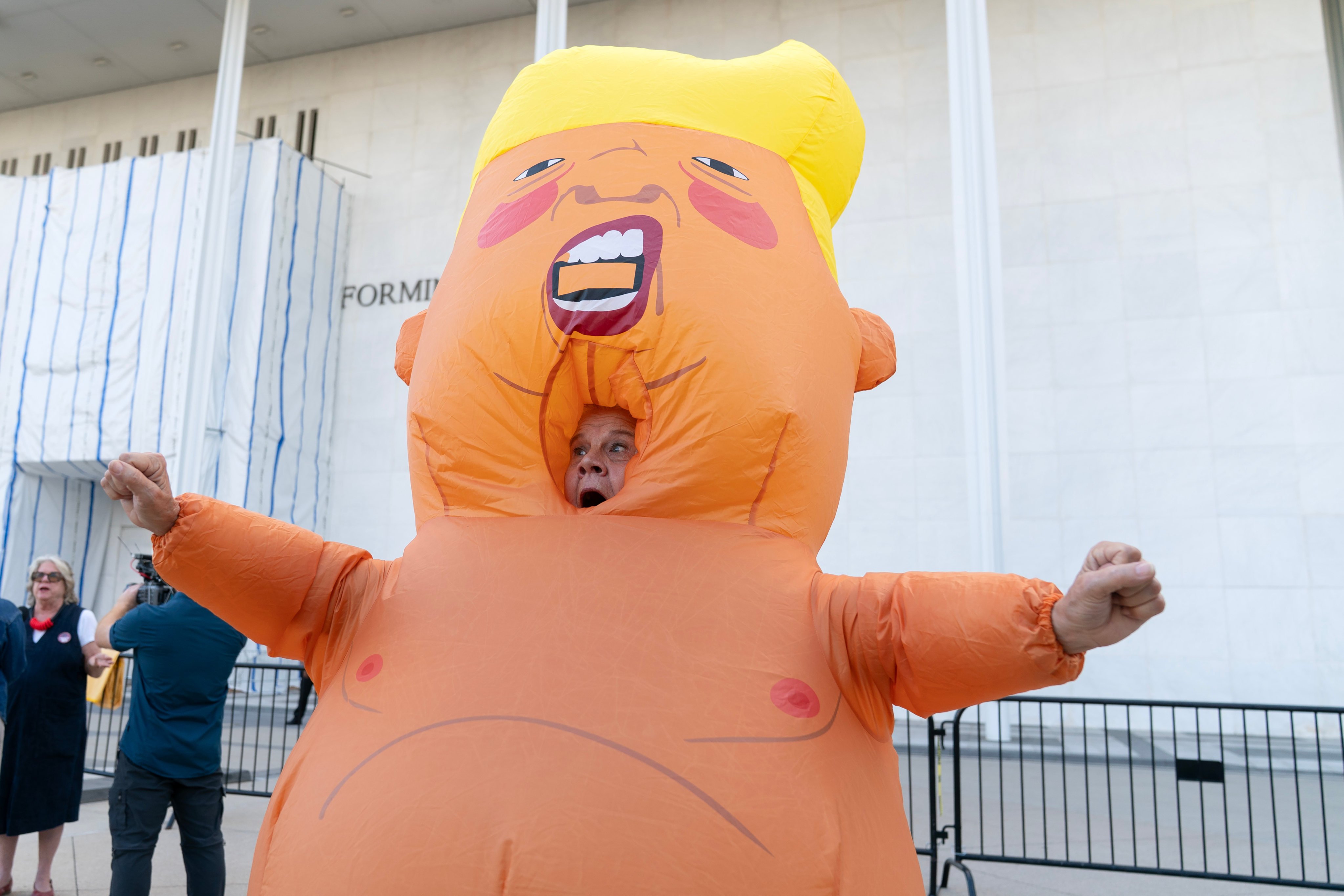 A demonstrator in an inflatable costume rallies against the closing of the Kennedy Centre on Friday. Photo: AP