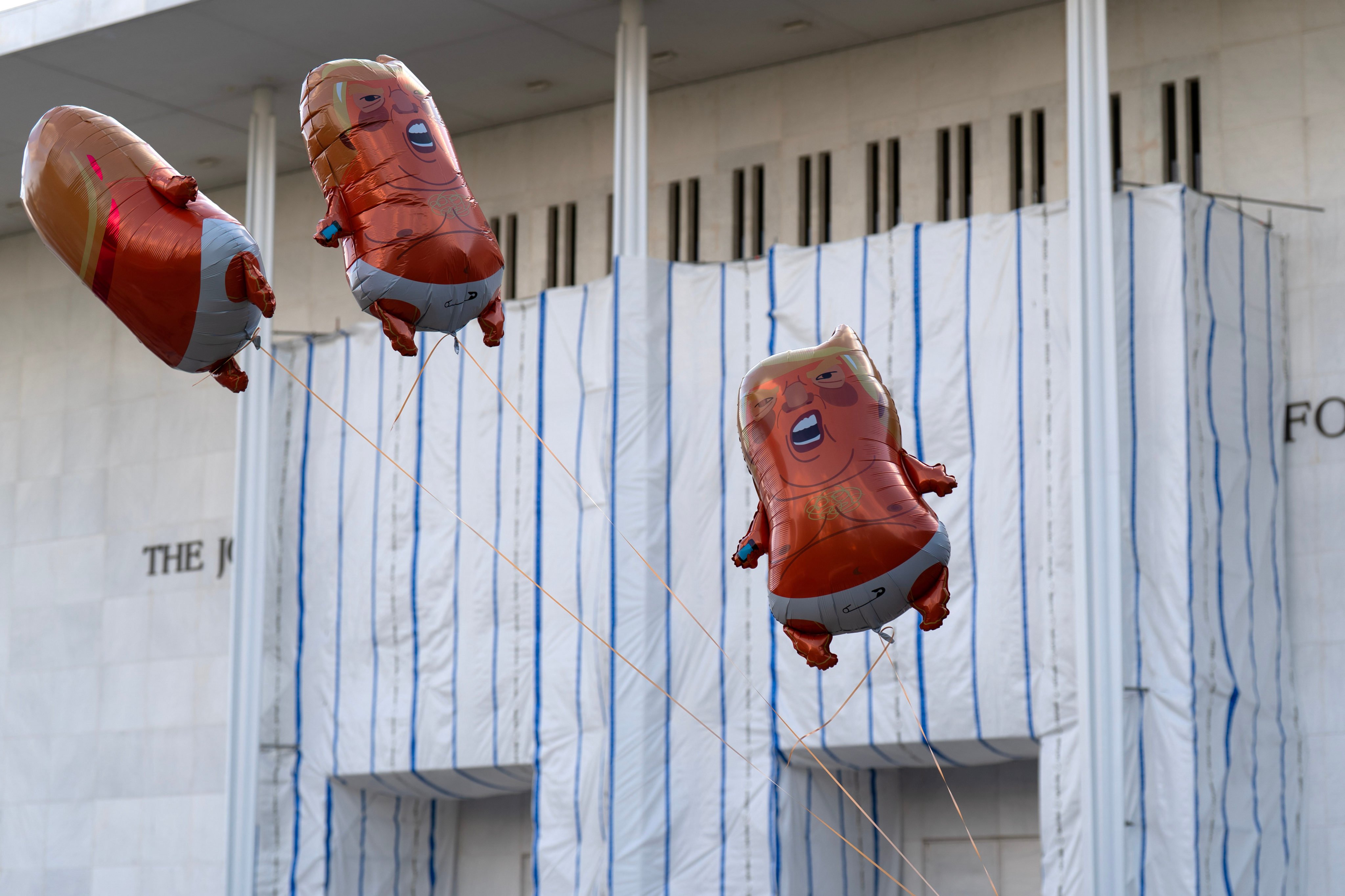 Donald Trump balloons fly over a protest against the closing of the Kennedy Centre on Friday. Photo: AP