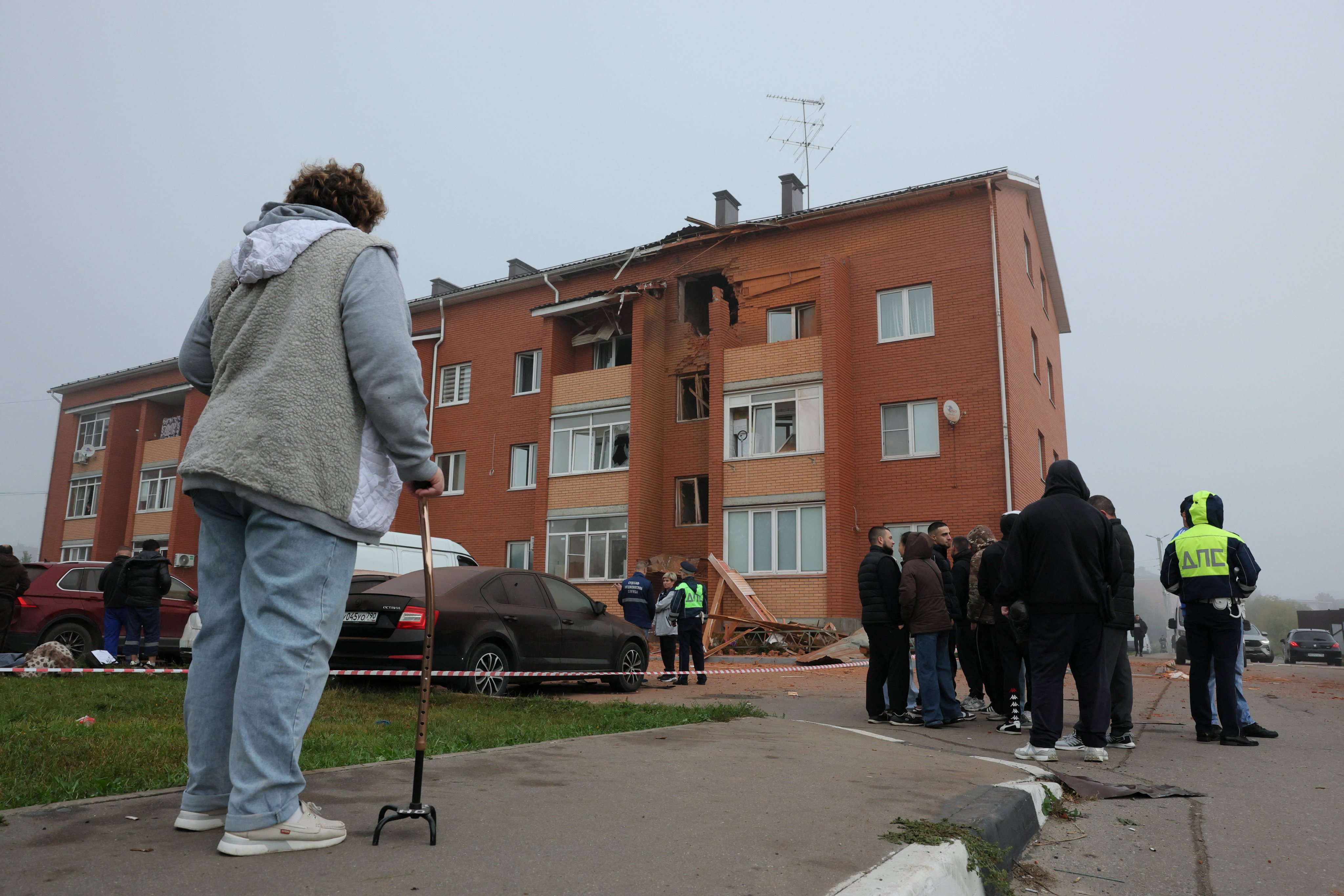 People gather outside a residential building damaged in a Ukrainian drone strike in the Ramensky district of the Moscow region on Sunday. Photo: Reuters
