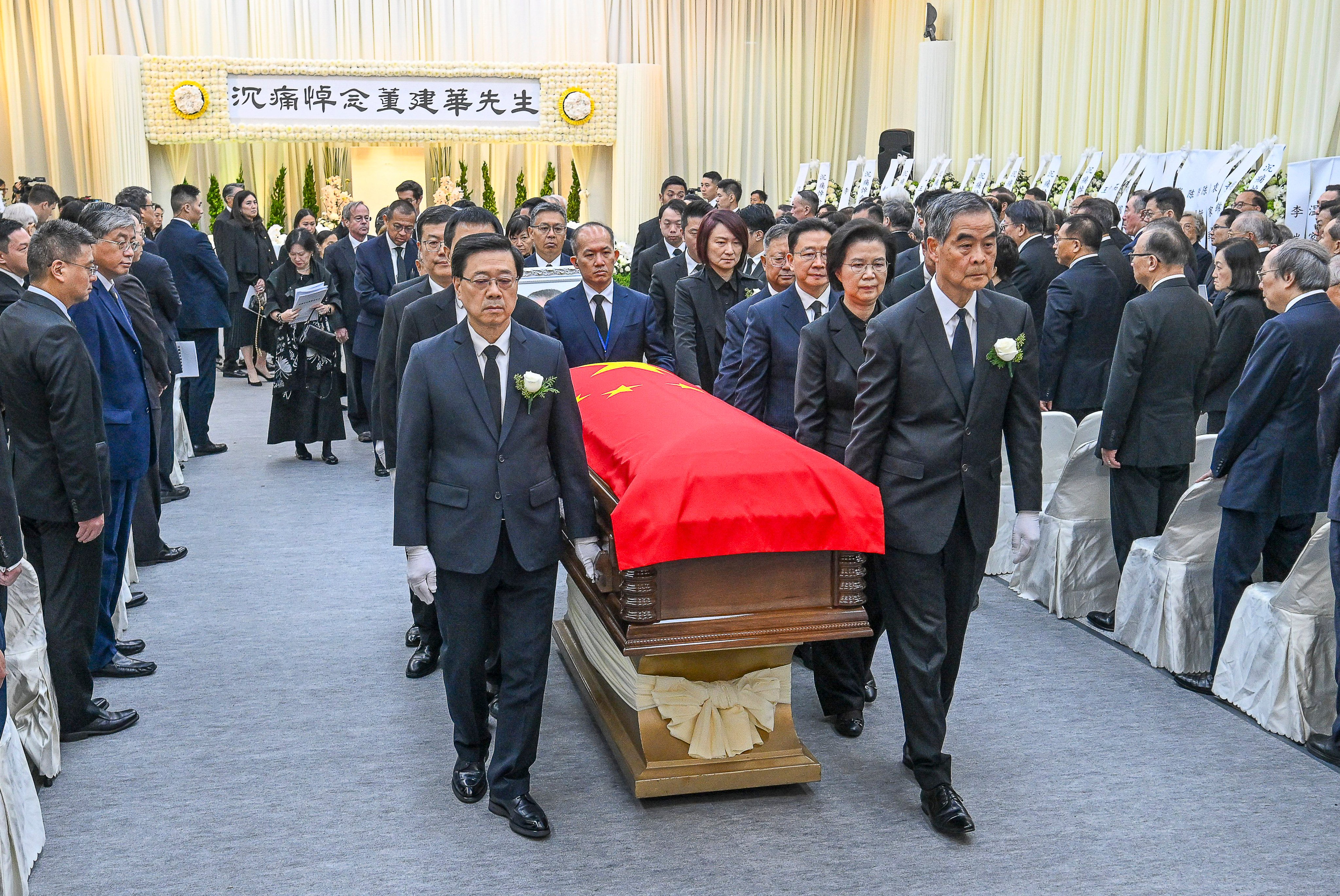 The coffin with the body of Tung Chee-hwa is carried by Hong Kong Chief Executive John Lee (front left pallbearer) and Leung Chun-ying (front right pallbearer), a CPPCC vice-chairman and former city leader, at the Hong Kong Funeral Home in North Point on Sunday. Photo: Handout