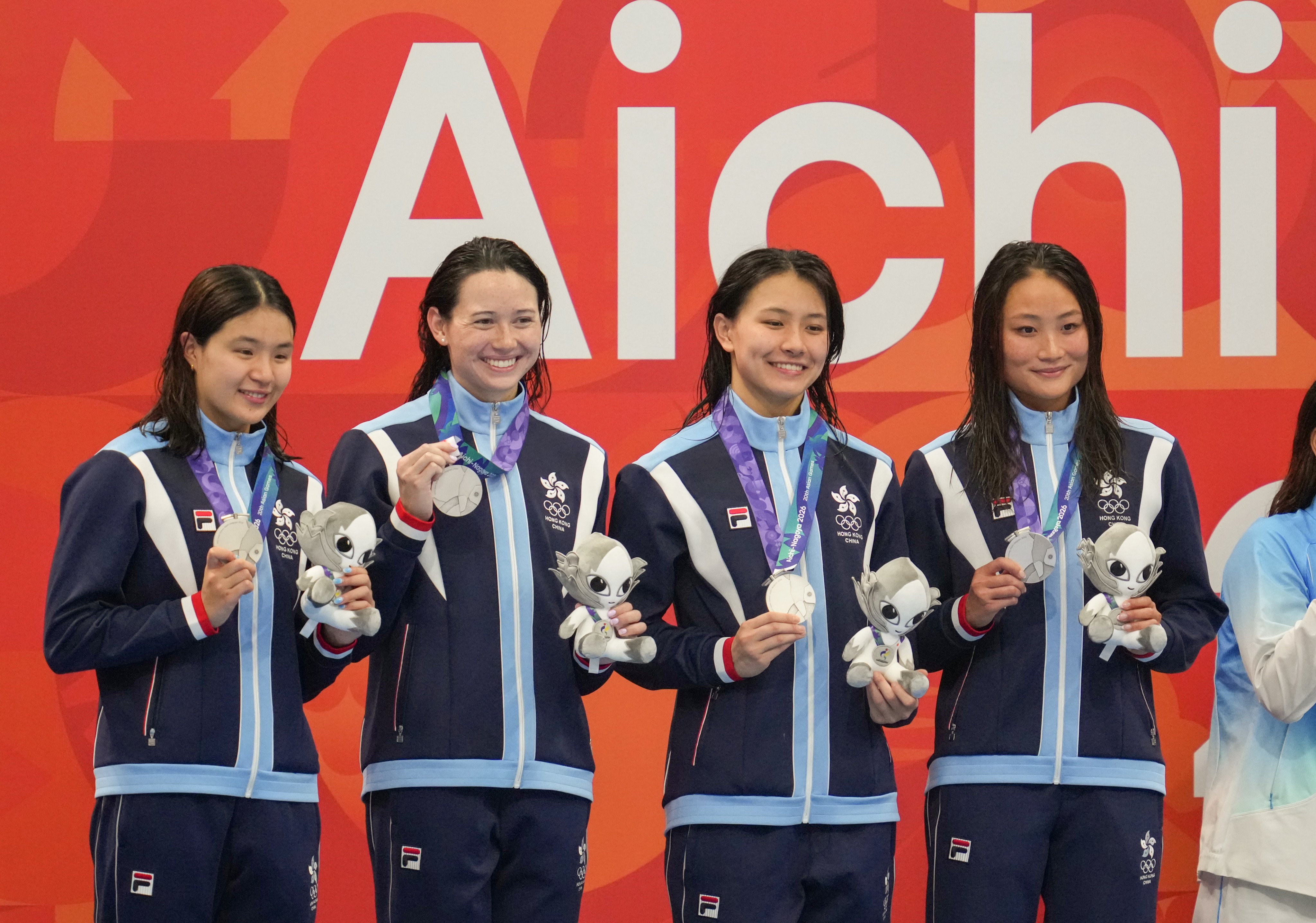 Hong Kong women’s 4x100m freestyle relay team celebrate after claiming silver at the Asian Games. Photo: Robert Ng