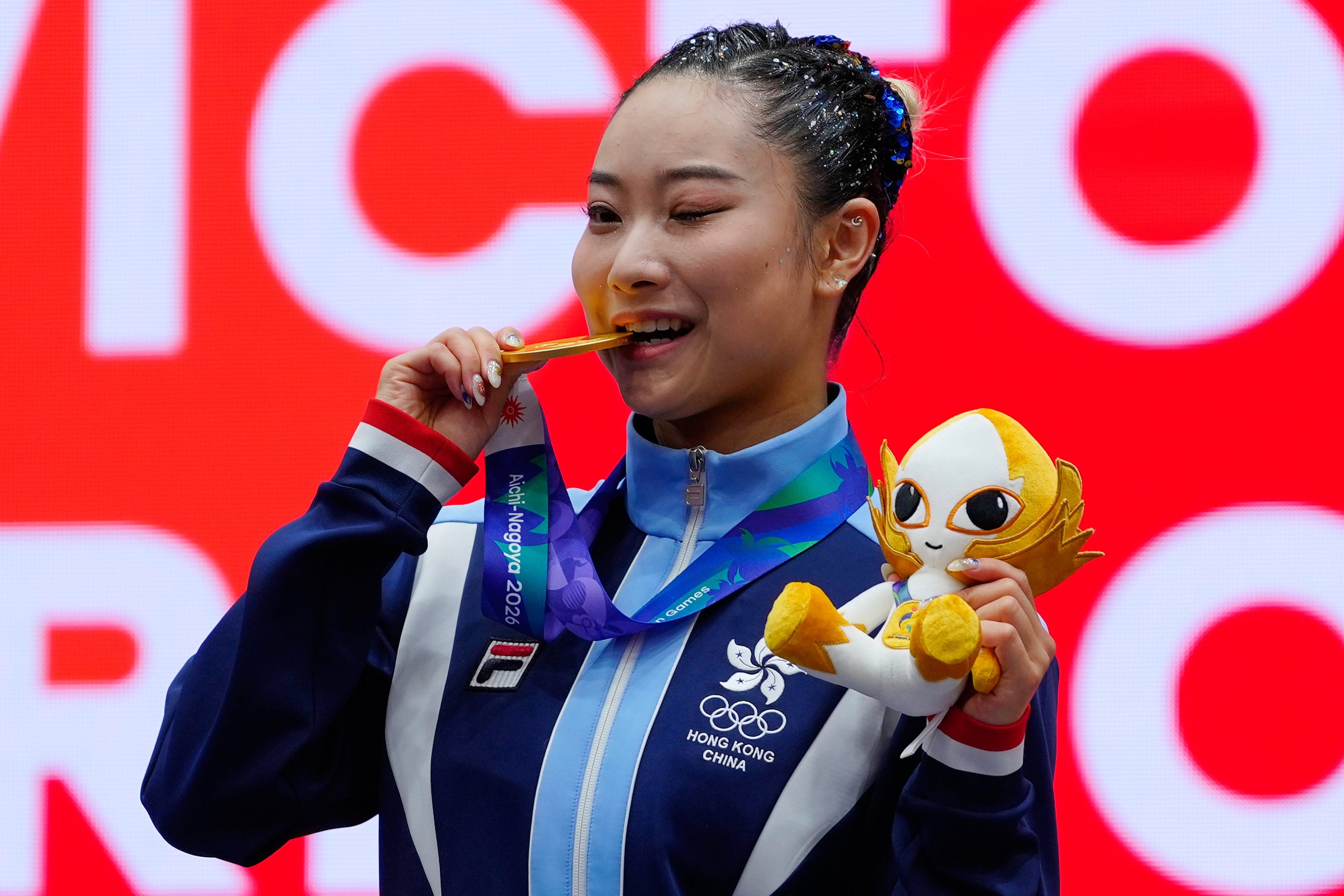 Lydia Sham celebrates  women’s wushu changquan gold at the Asian Games. Photo: AP