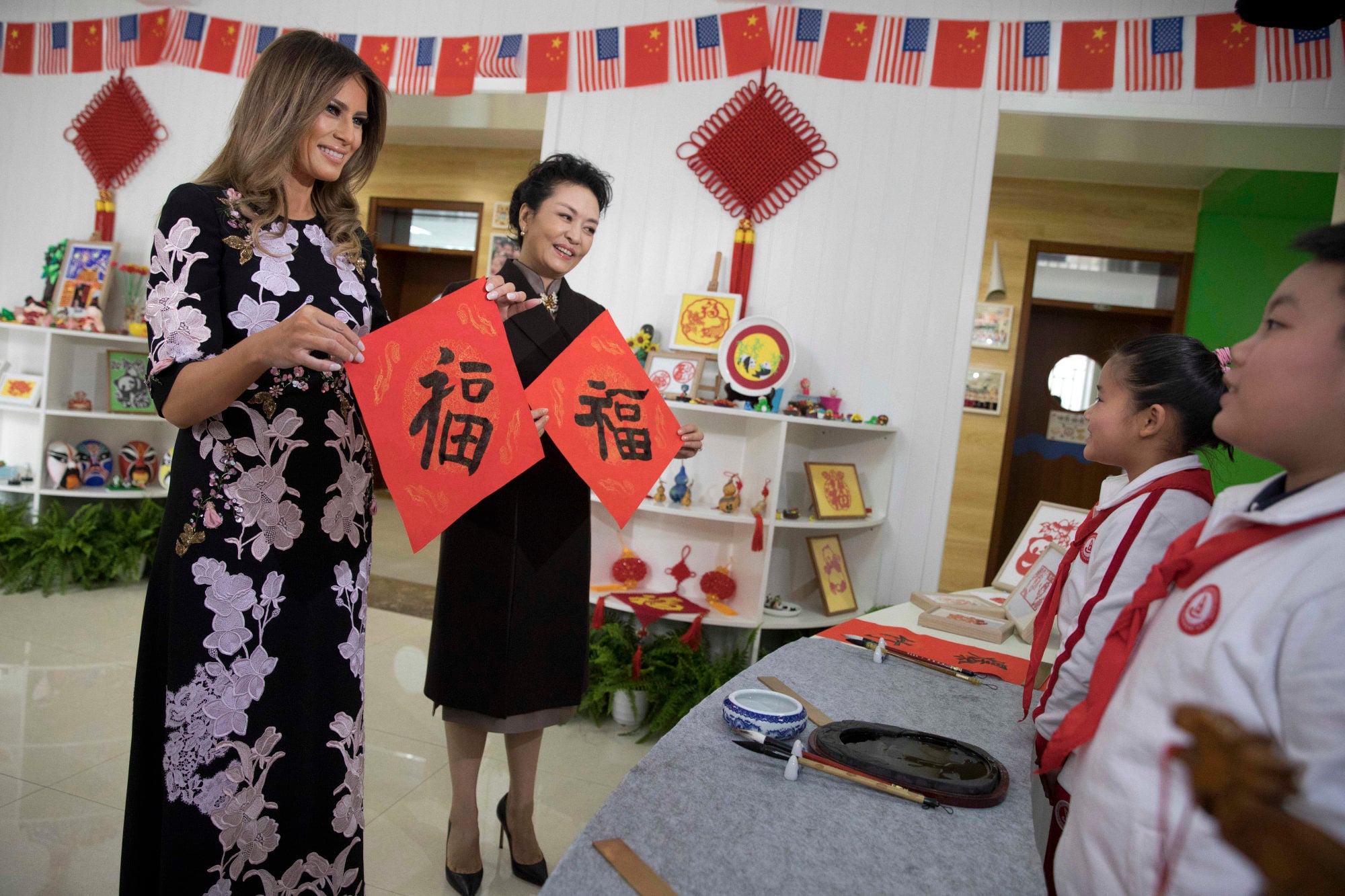 US first lady Melania Trump and Chinese first lady Peng Liyuan hold up Chinese calligraphy of the characters for “fortune” written by students during a visit to the Banchang Primary School in Beijing in November 2017. Photo: AP US first lady Melania Trump and Chinese first lady Peng Liyuan hold up Chinese calligraphy of the characters for “fortune” written by students during a visit to the Banchang Primary School in Beijing in November 2017. Photo: AP
