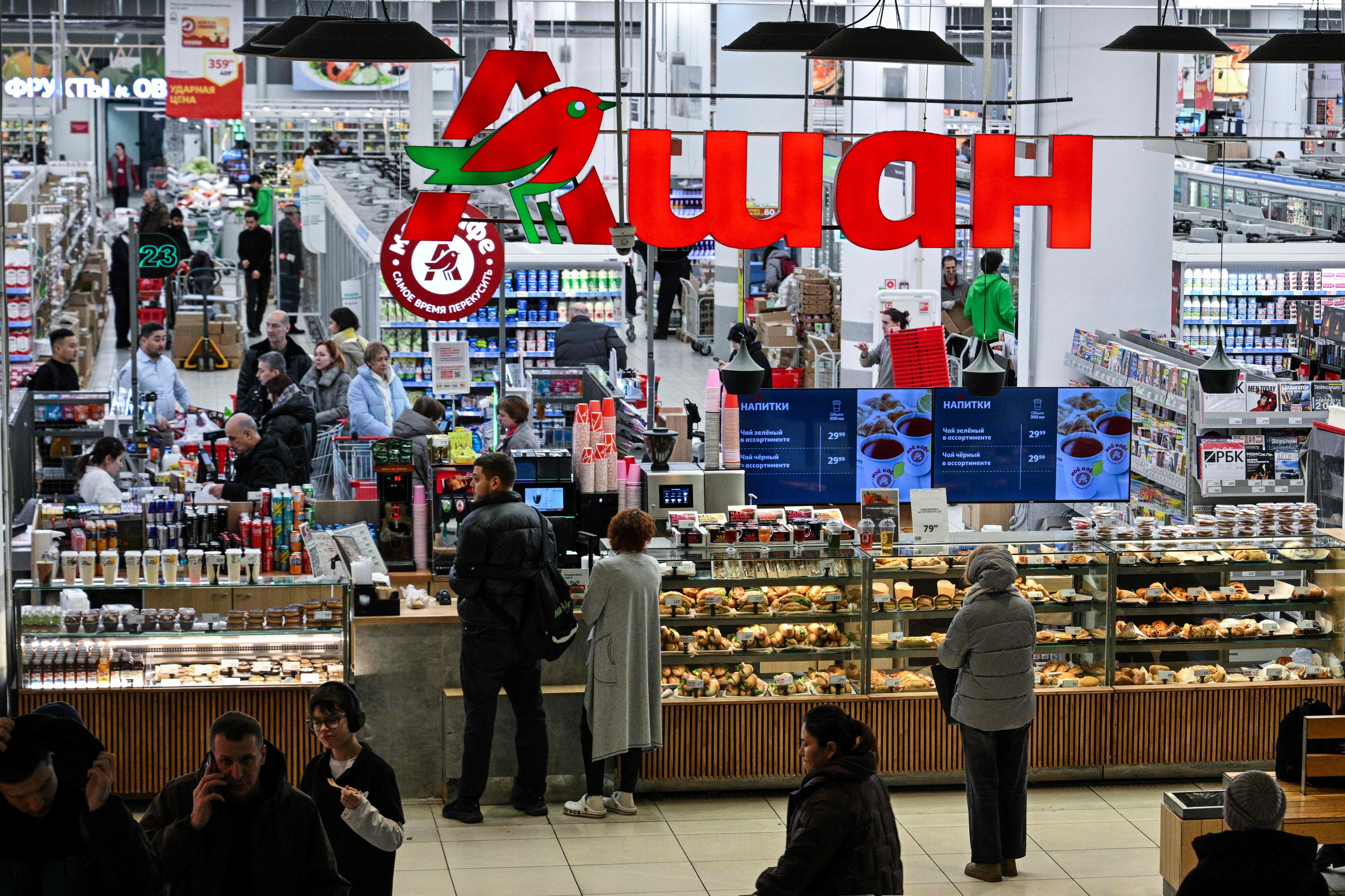 Customers shop at an Auchan supermarket in Moscow earlier this year. French retailer Auchan was among the Western brands whose assets were seized by the Kremlin last week. Photo: AFP