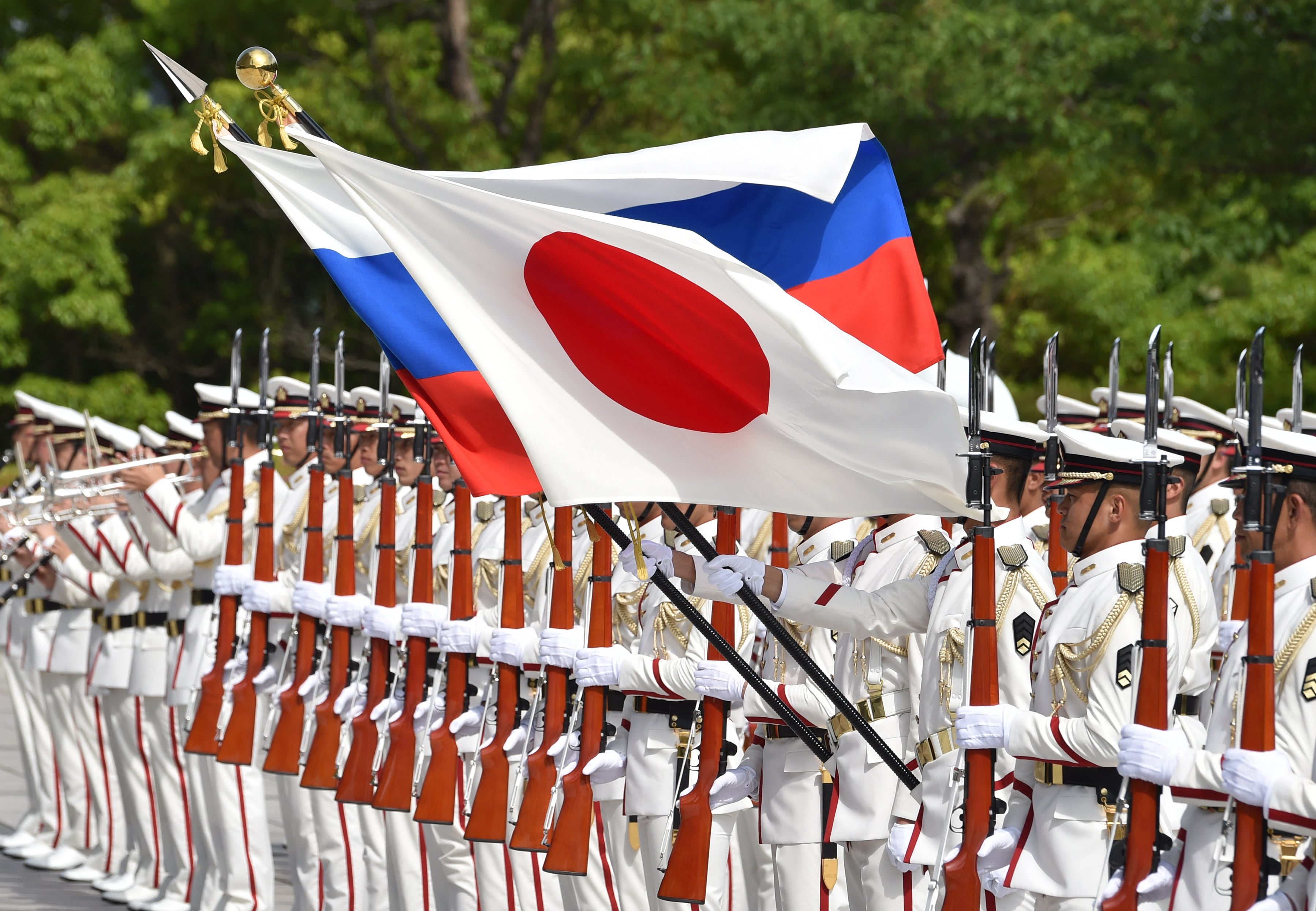 Honour guards hold the national flags of Japan and Russia before a welcome ceremony for Sergei Shoigu in 2019, the last time a Russian defence minister visited Tokyo. Photo: AFP