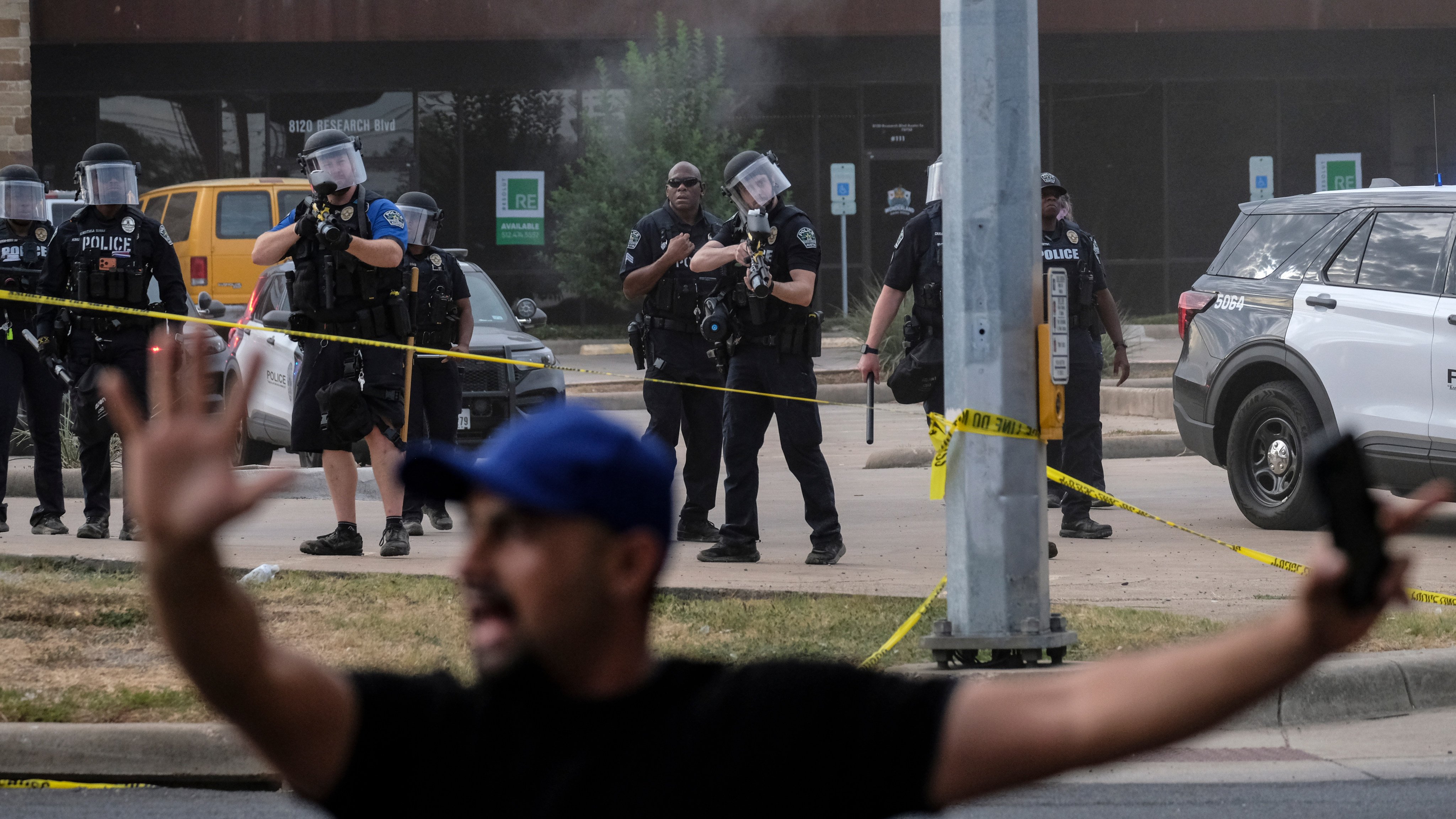 Authorities deploy non-lethal weapons near a demonstration where a man was shot by an ICE officer in Austin, Texas. Photo: AP