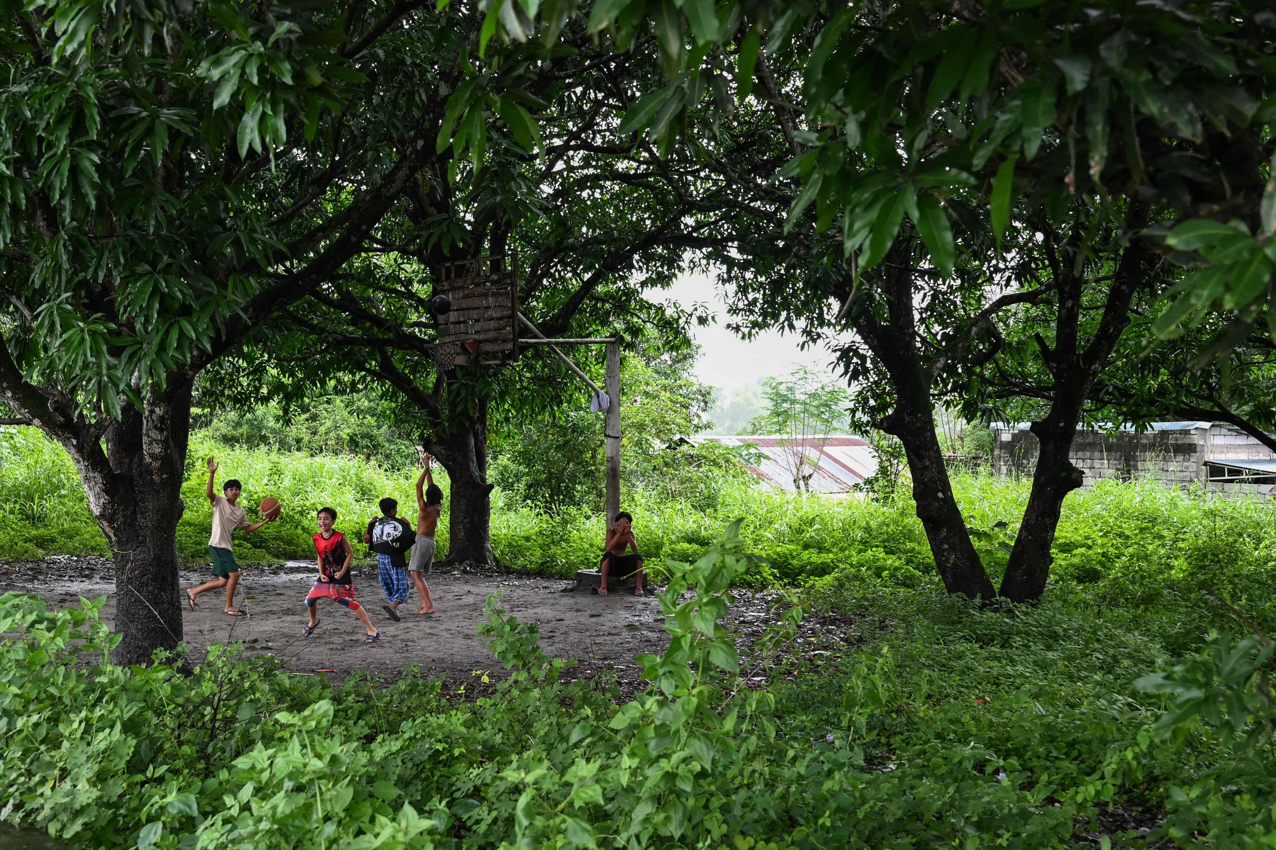 Aeta children play basketball in Capas, Tarlac province, on August 10. Photo: AFP