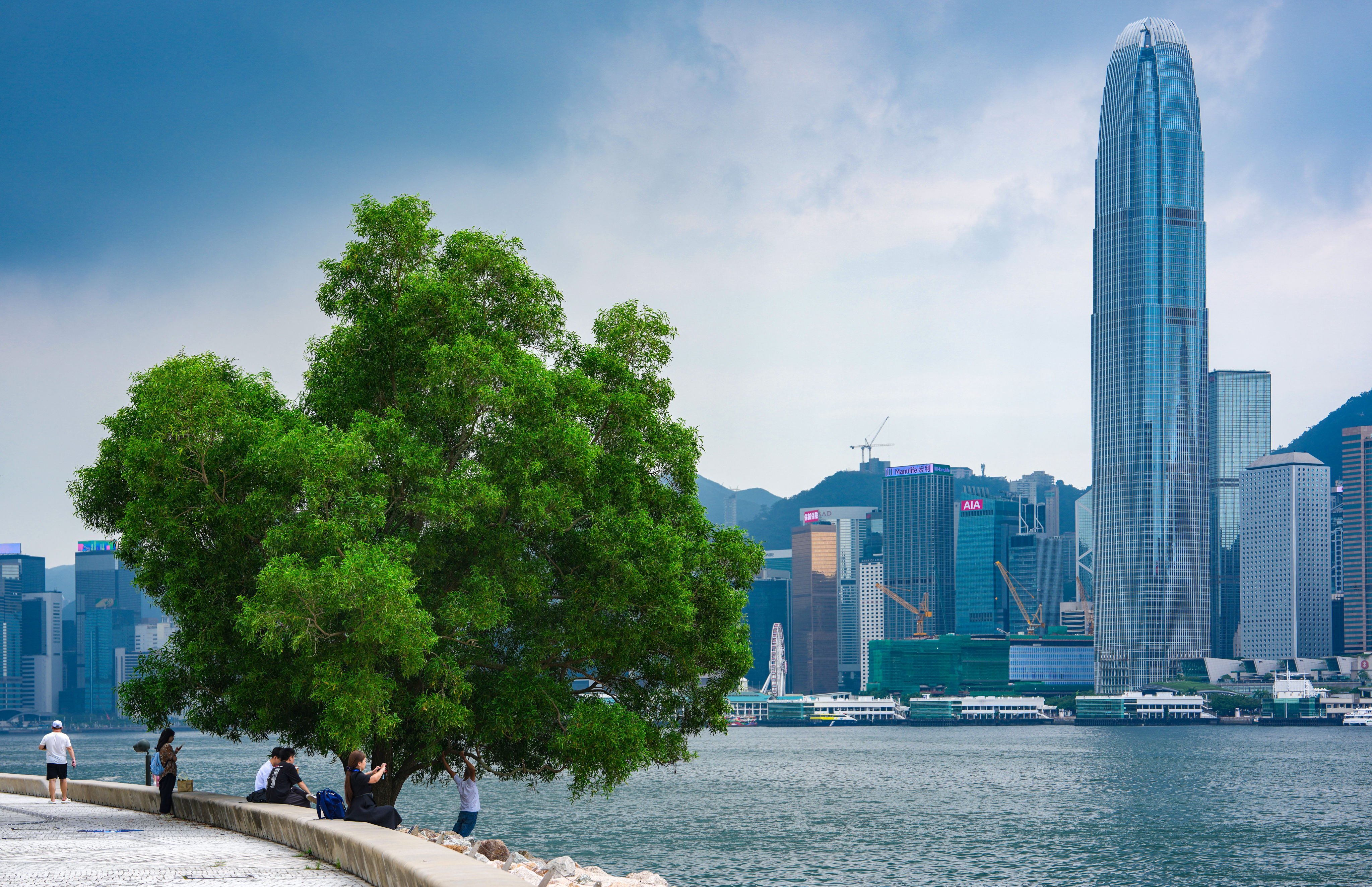 People enjoy the waterfront at the West Kowloon Cultural District in Hong Kong, on September 7. Photo: Sam Tsang