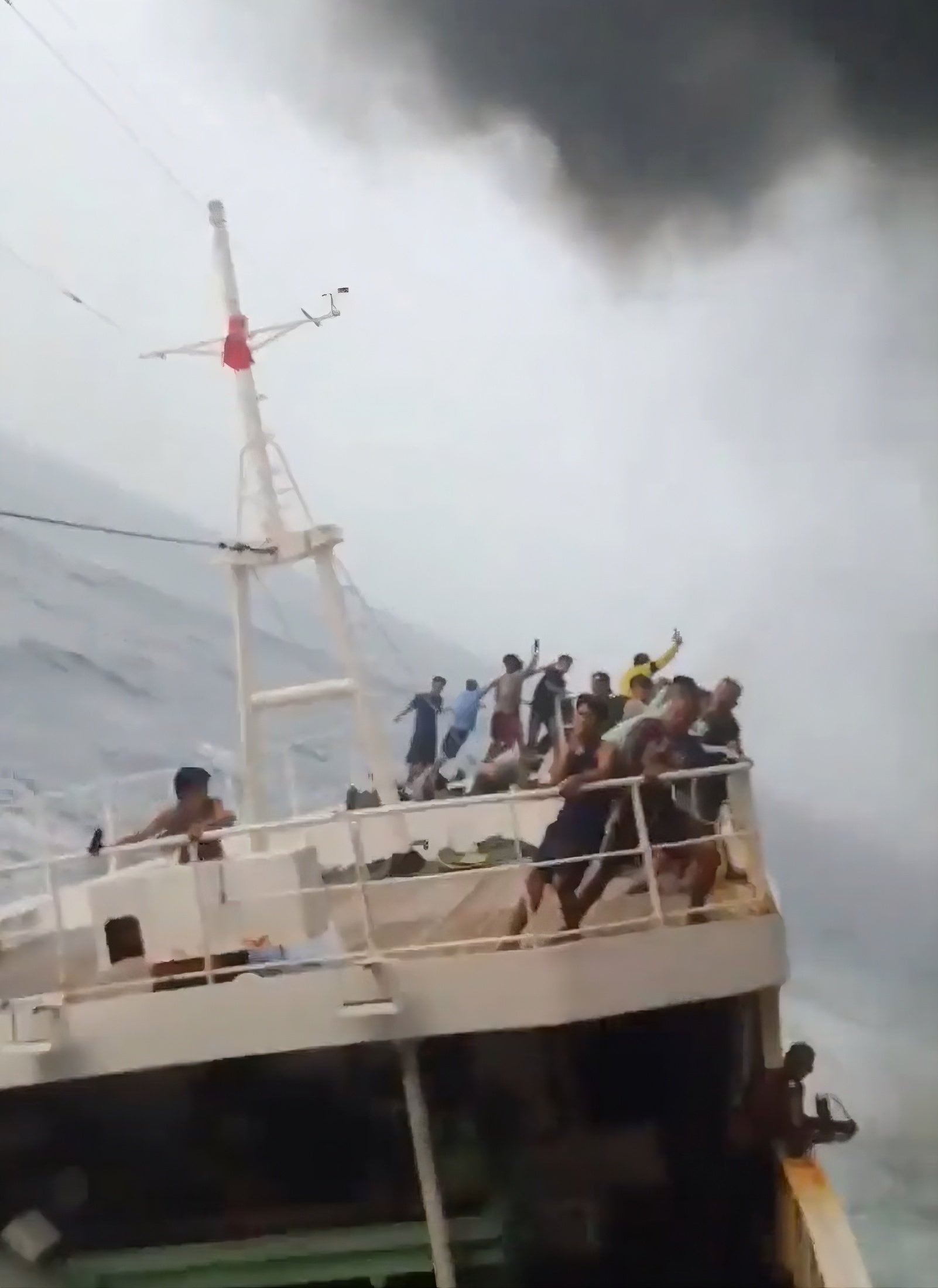 A still from a social media video shows crew members clinging to railings in the aftermath of the ship collision in the Singapore Strait last week. Photo: X