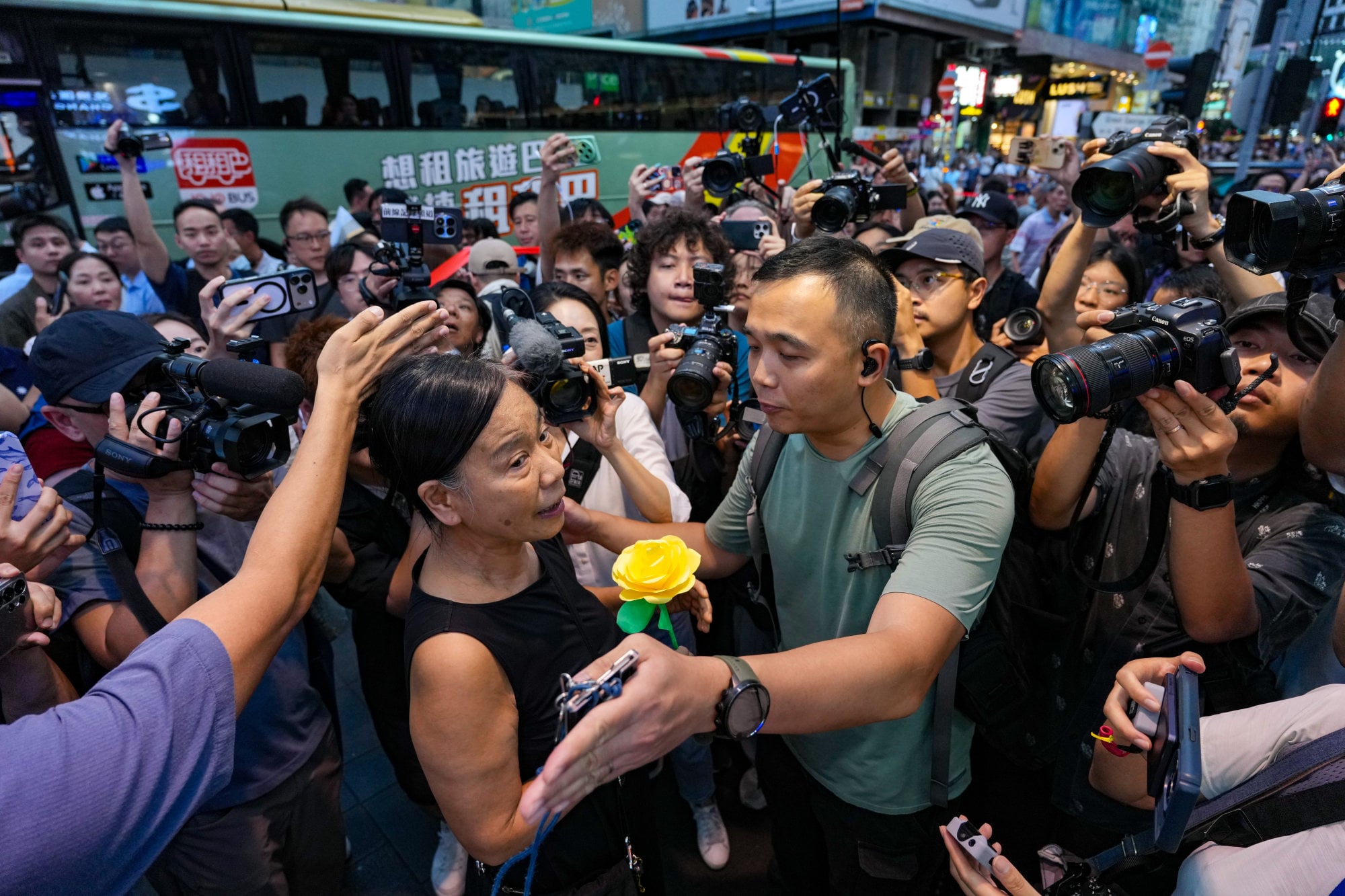 Activist Chan Po-ying (centre) appears at Victoria Park with a paper yellow flower to mark June 4. Kan said commemorative activities should be judged on a case-by-case basis. Photo: Karma Lo