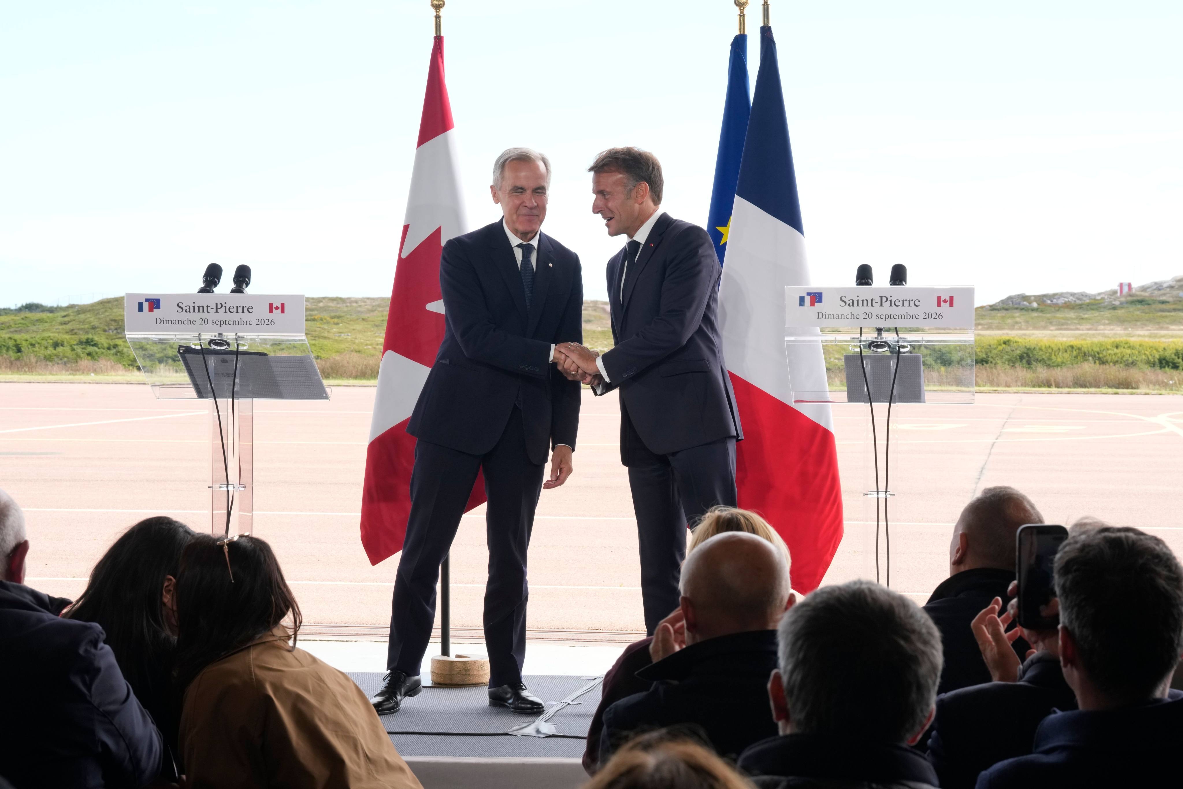 French President Emmanuel Macron (right) and Canadian Prime Minister Mark Carney shake hands after their meeting in the French territory of Saint-Pierre and Miquelon off Canada’s Atlantic coast on Sunday. Photo: Canadian Press via Zuma Press / dpa