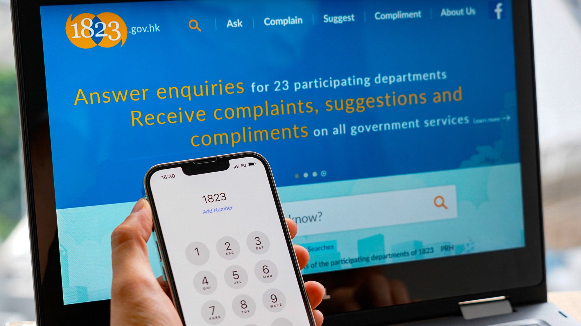 A new handling mechanism for the 1823 hotline is set to be implemented early next year. Photo: ISD