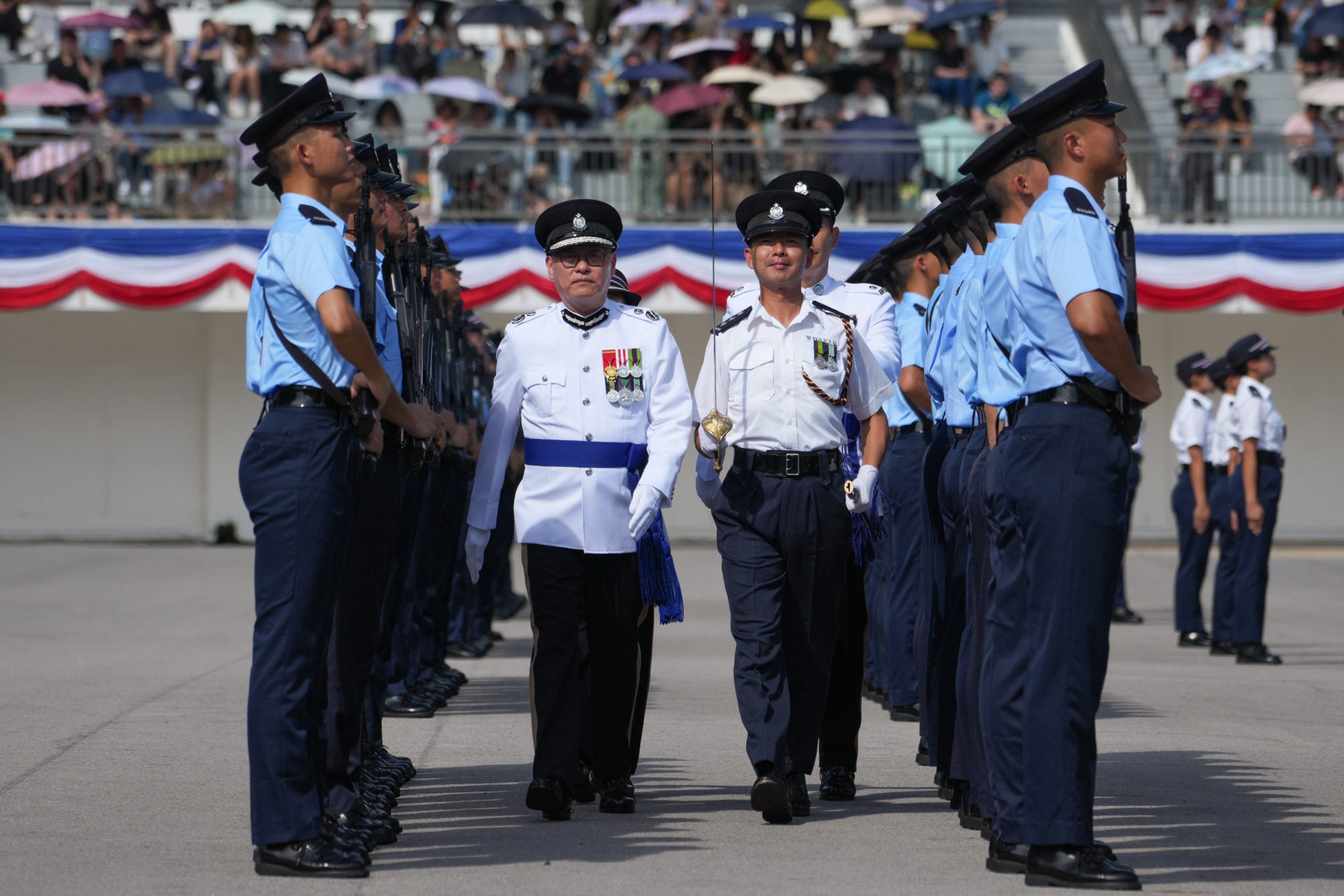 Andrew Kan (second left) inspects a passing-out parade held at the Hong Kong Police College. Photo: Handout