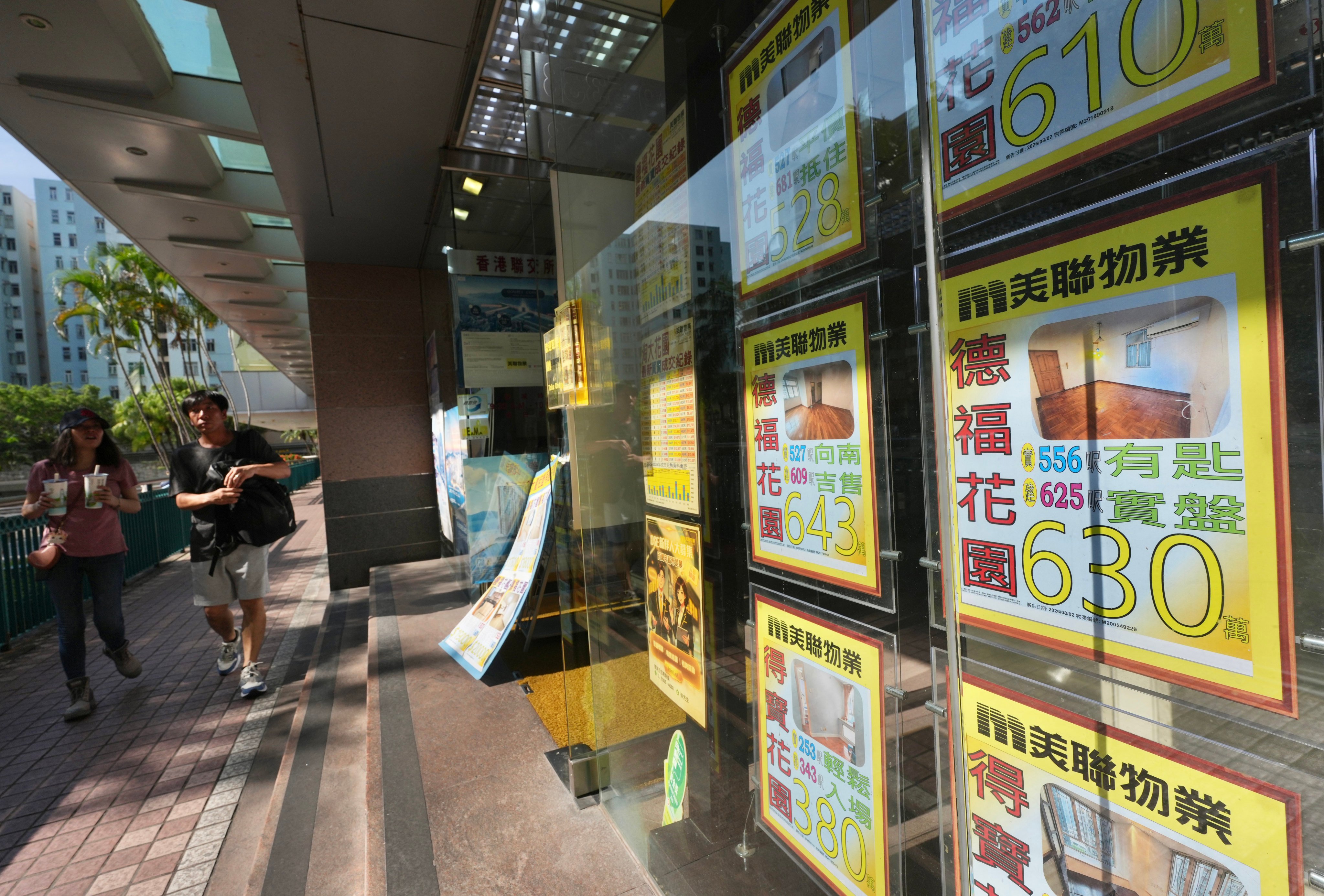 People walk past a real estate agency in Telford Plaza, Kowloon Bay, Hong Kong on August 16. Photo: Karma Lo