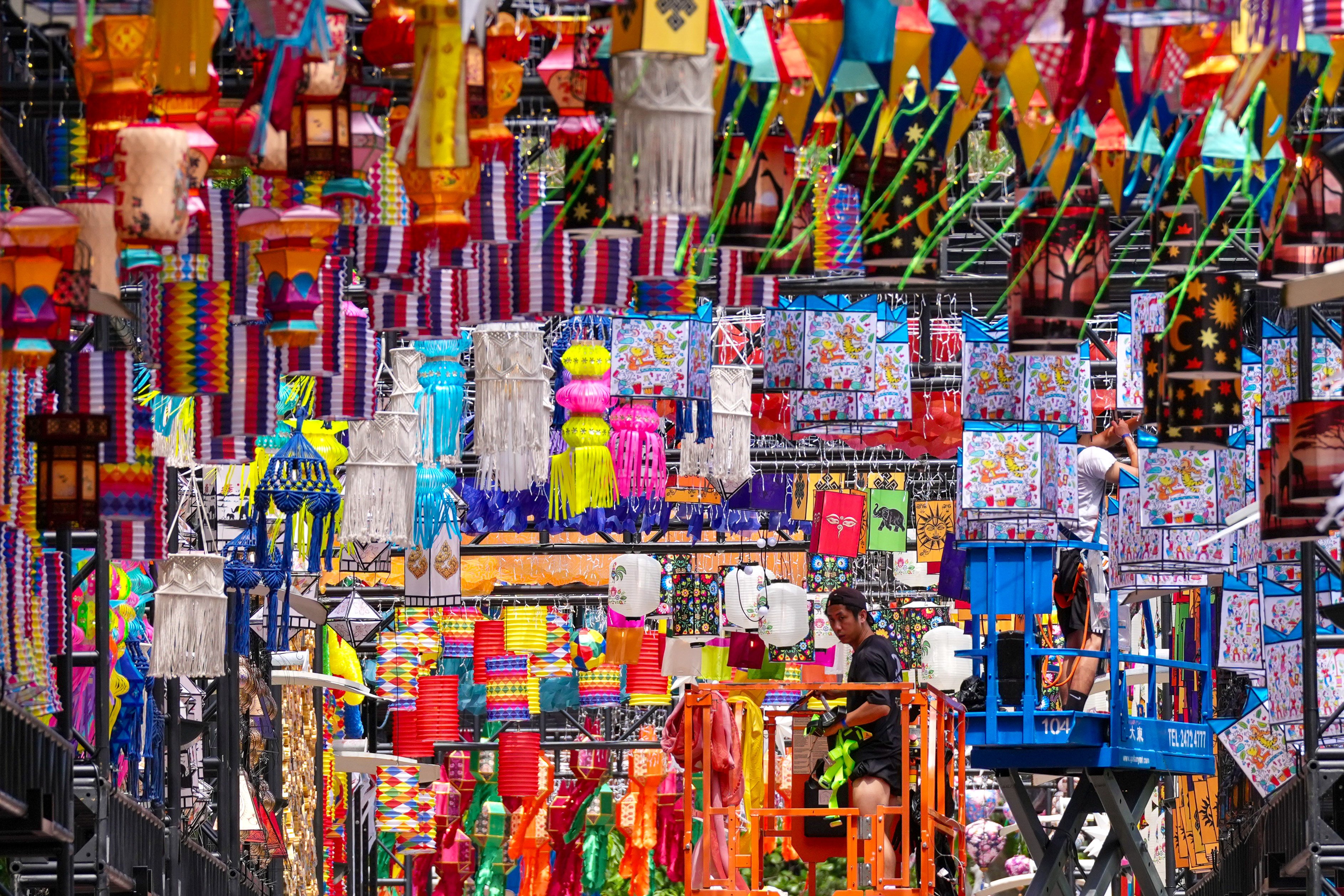 Workers put the finishing touches to a vibrant lantern display at Victoria Park in Causeway Bay. Photo: Karma Lo