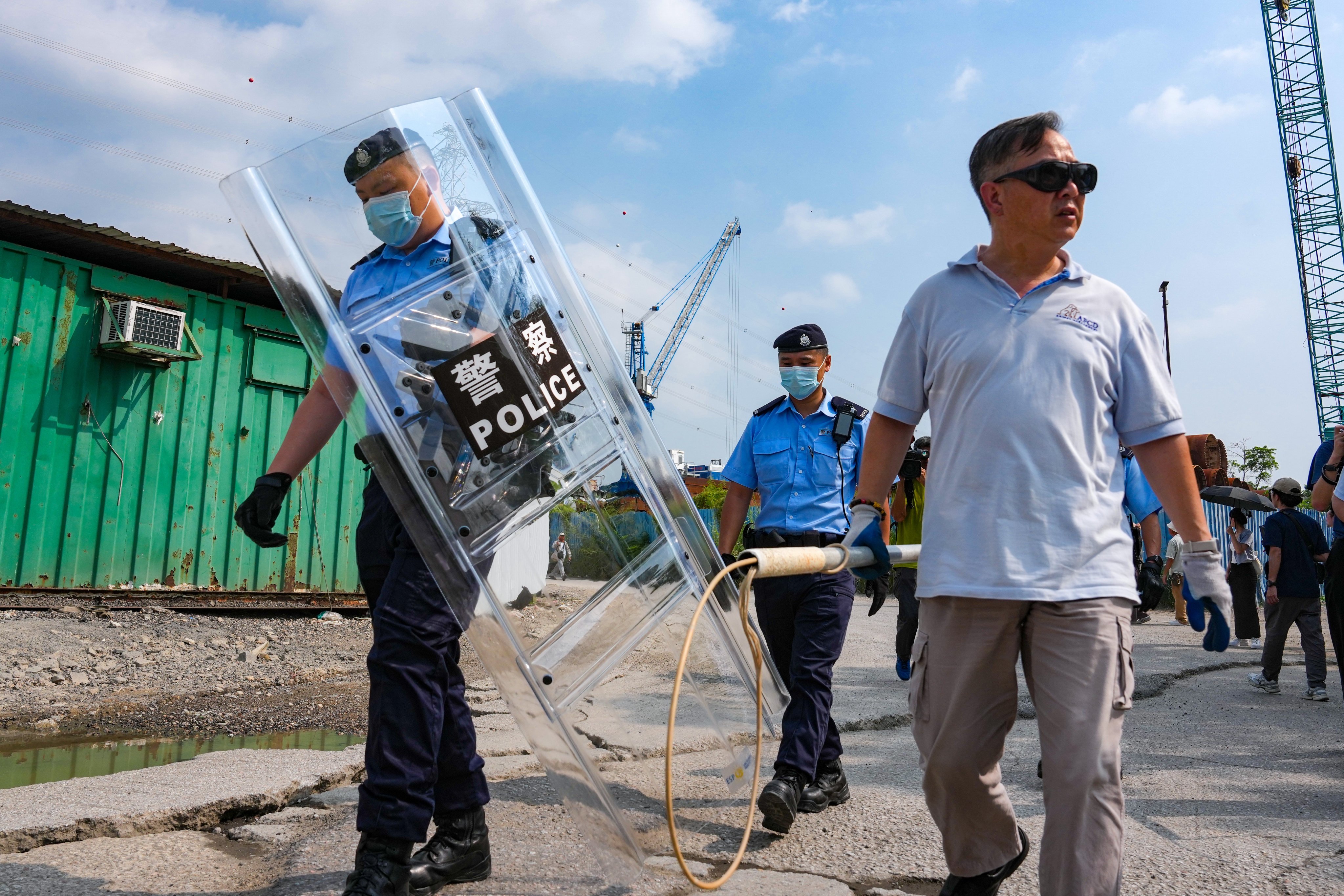 Hong Kong police and AFCD officers search for stray dogs in Yuen Long on Monday. Photo: Kit Lai