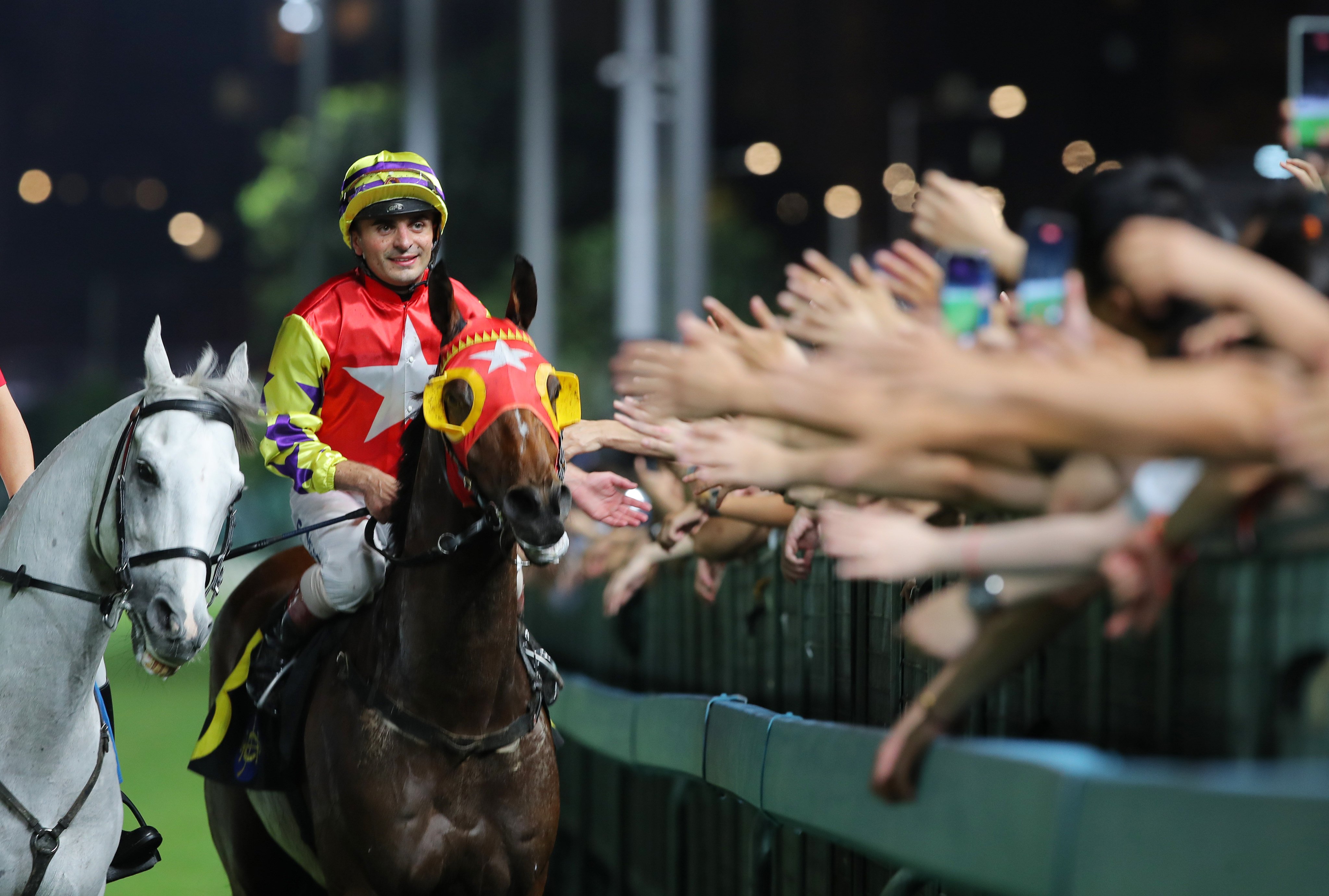 Andrea Atzeni celebrates his win on Crimson Flash last season with the Happy Valley crowd. Photos: Kenneth Chan