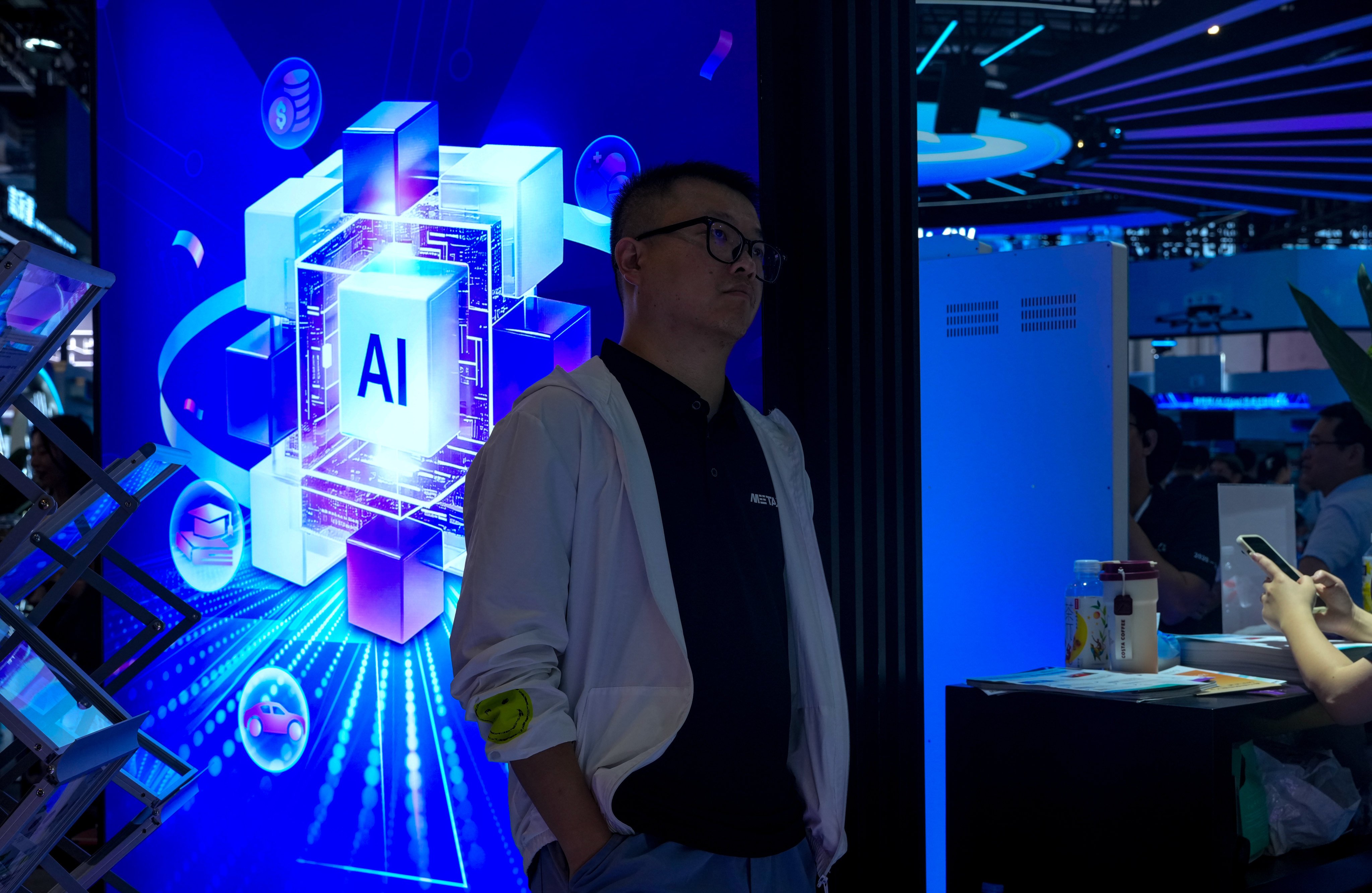 A visitor studies an AI-themed display at the World Artificial Intelligence Conference in Shanghai on July 17, 2026. Photo: AP