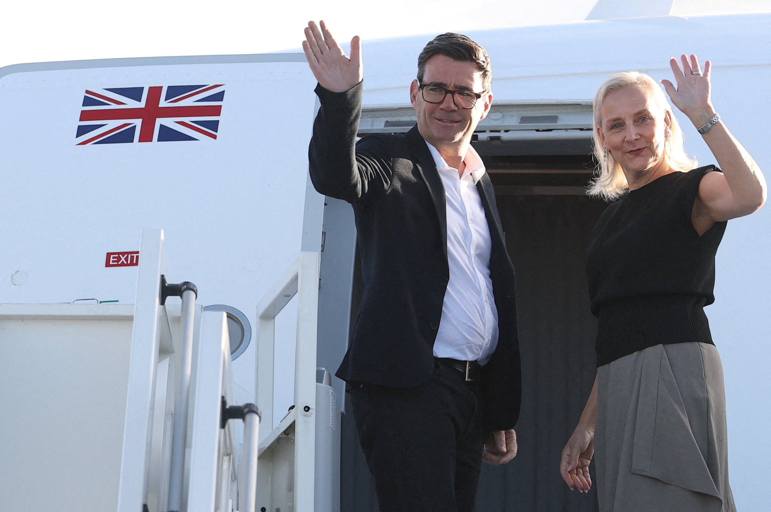 Britain’s Prime Minister Andy Burnham and his wife Marie-France van Heel board a plane for the United States. Photo: Reuters