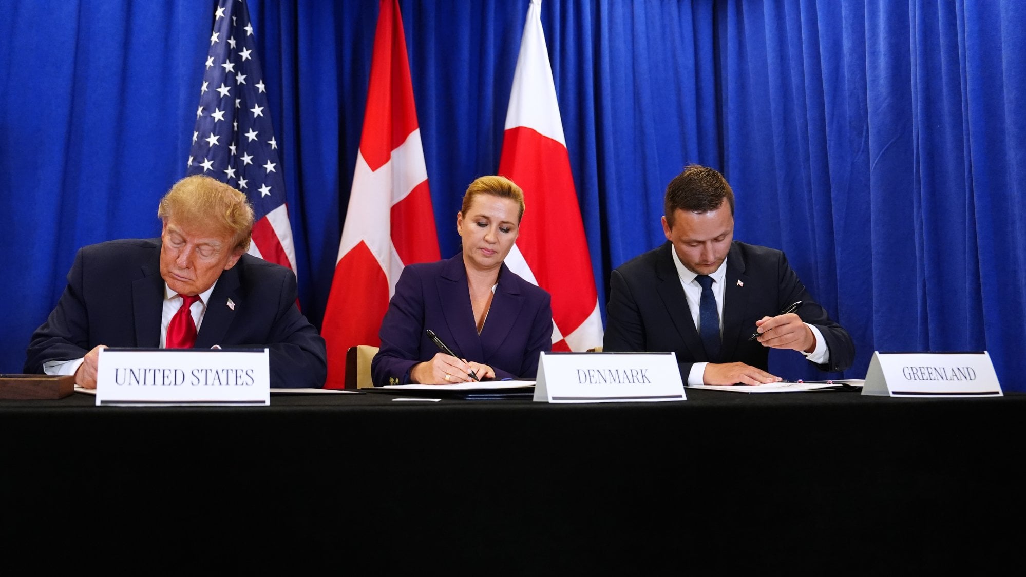 From left: US President Donald Trump signs a Greenland security agreement with Danish Prime Minister Mette Frederiksen and Greenlandic Prime Minister Jens-Frederik Nielsen at the UN on Tuesday. Photo: AP