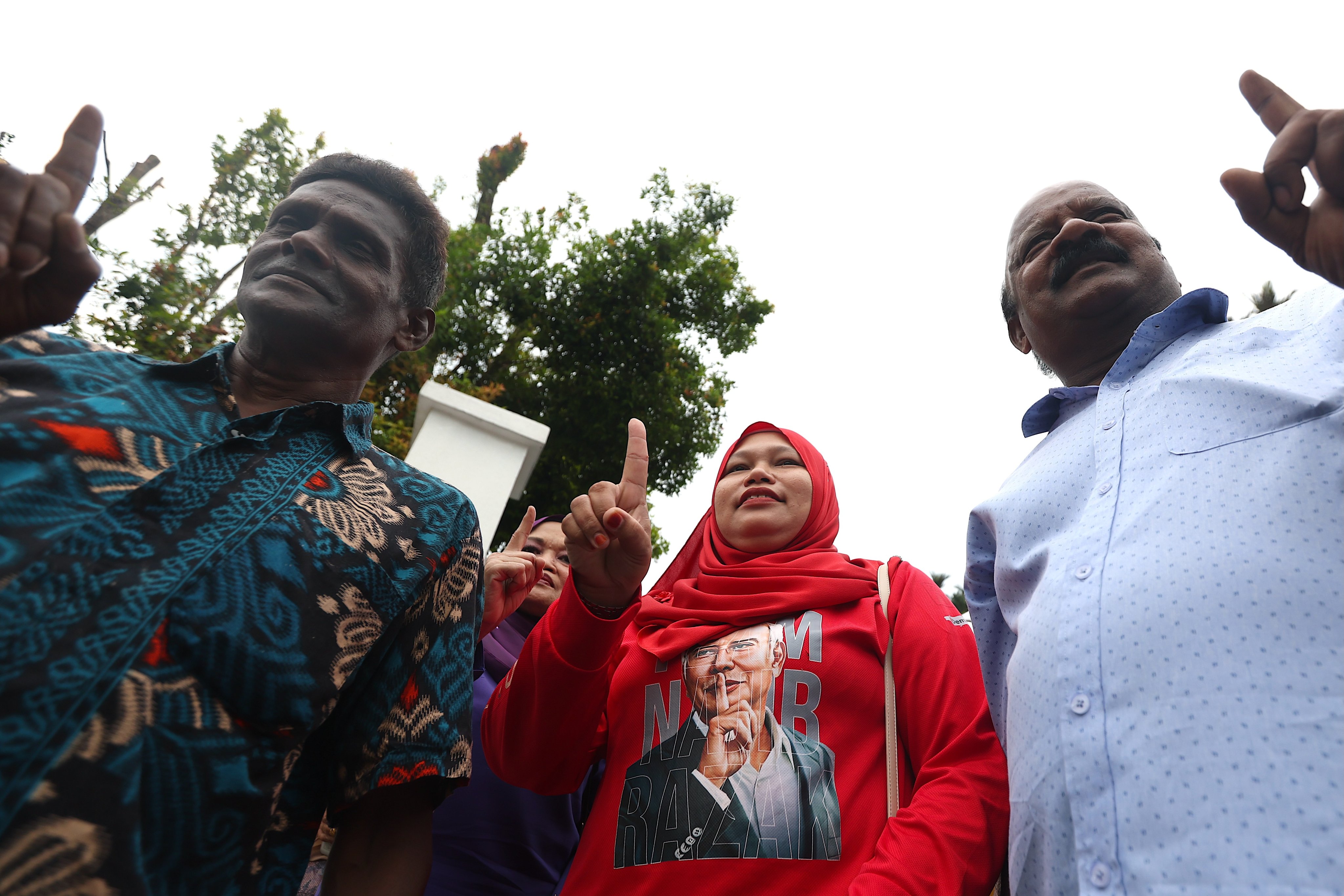 Supporters of Malaysia’s former prime minister Najib Razak gather outside his house in Kuala Lumpur on Friday. Photo: EPA