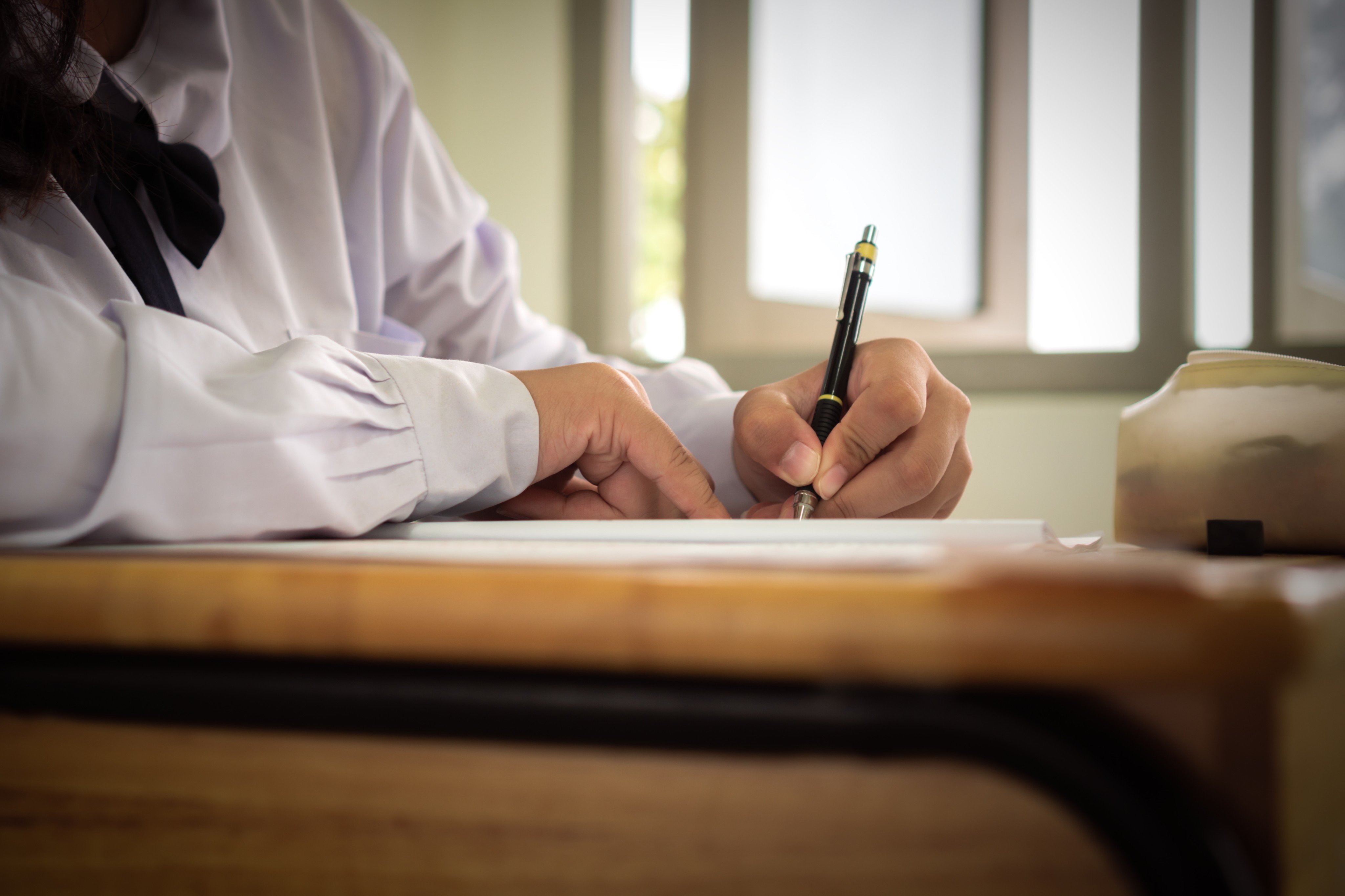 When you take notes by hand, your brain has to work harder to process what your teacher says. Photo: Shutterstock