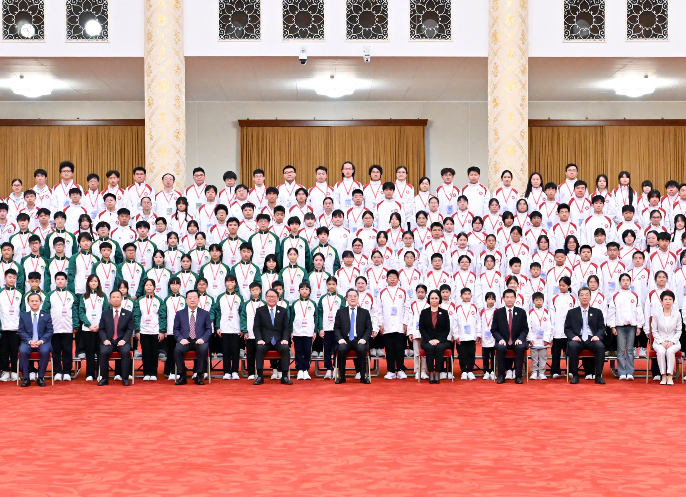 Chinese Vice-Premier Ding Xuexiang (front, fifth from left) joins students from Hong Kong and Macau for a group photo. Photo: Xinhua
