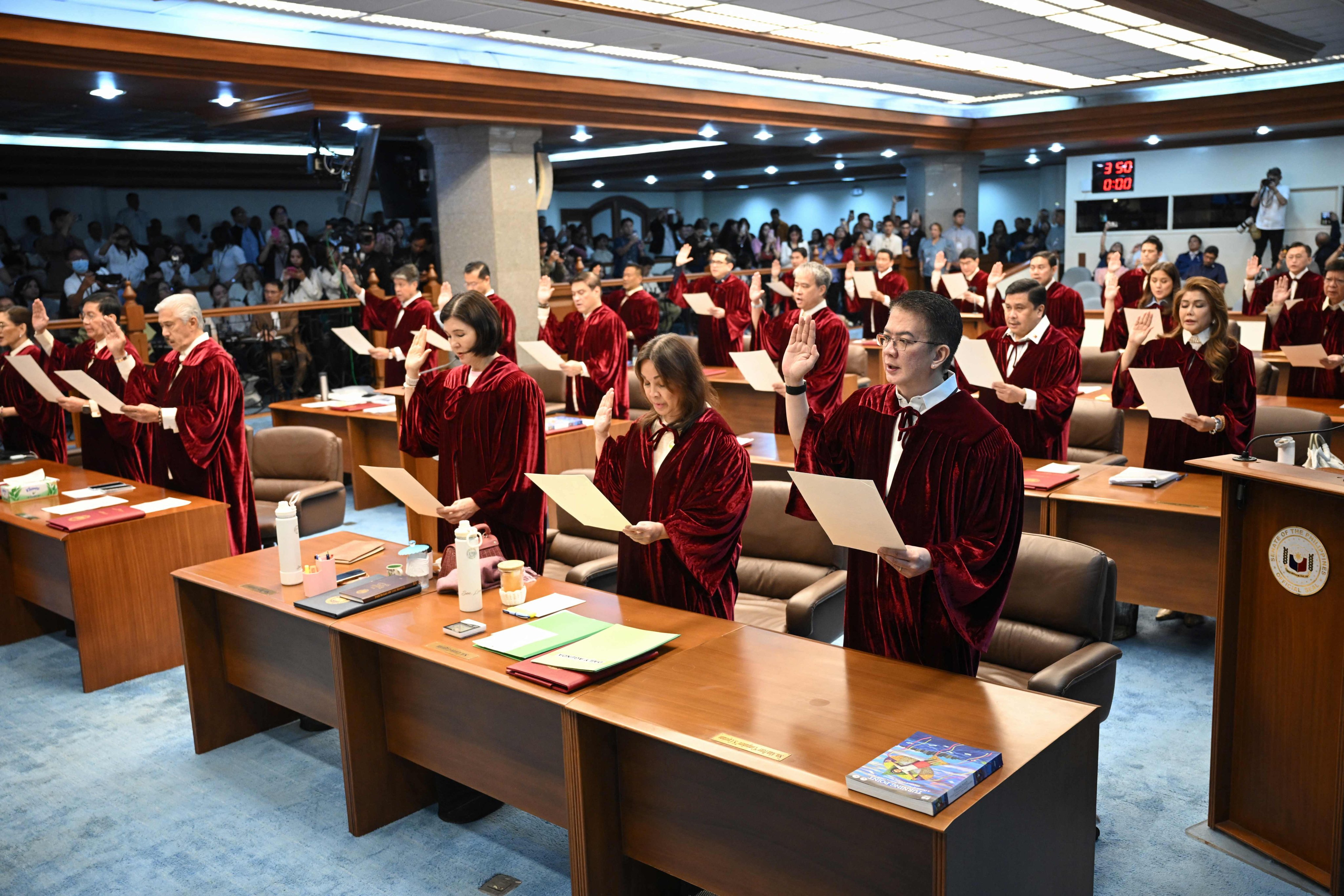 Philippine senators are sworn in as jurors for the impeachment trial of Vice-President Sara Duterte-Carpio at the Senate in Manila in May. Photo: AFP