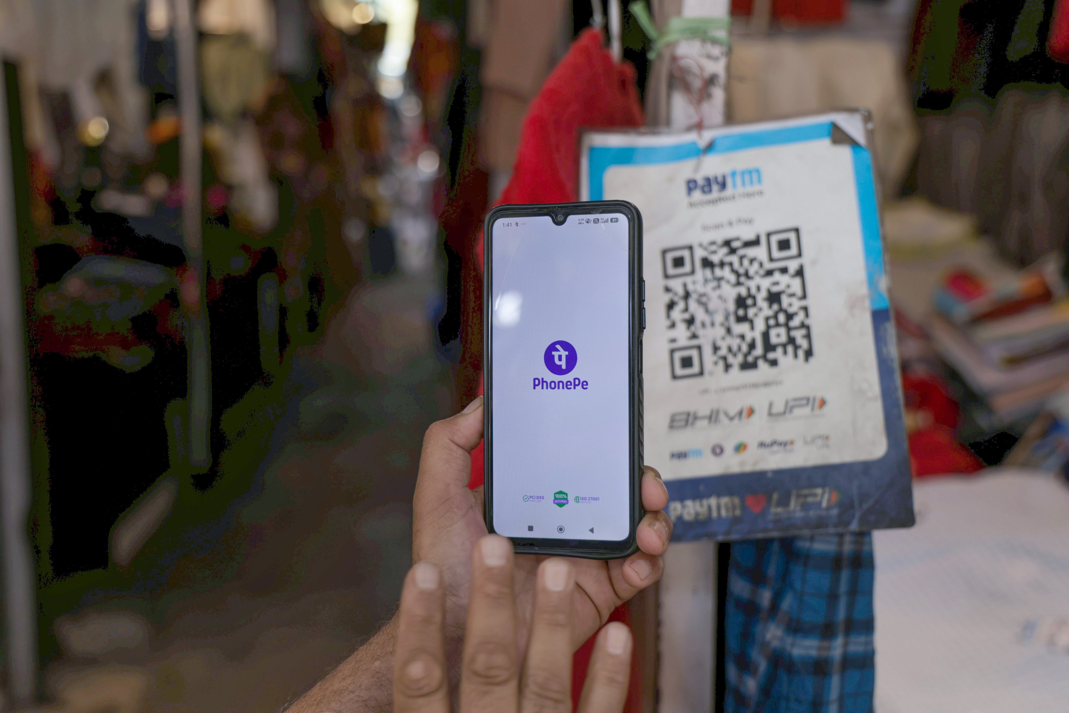 A customer makes a payment through the Unified Payments Interface at a shop in Srinagar,  Indian Kashmir, on September 16. Photo: EPA