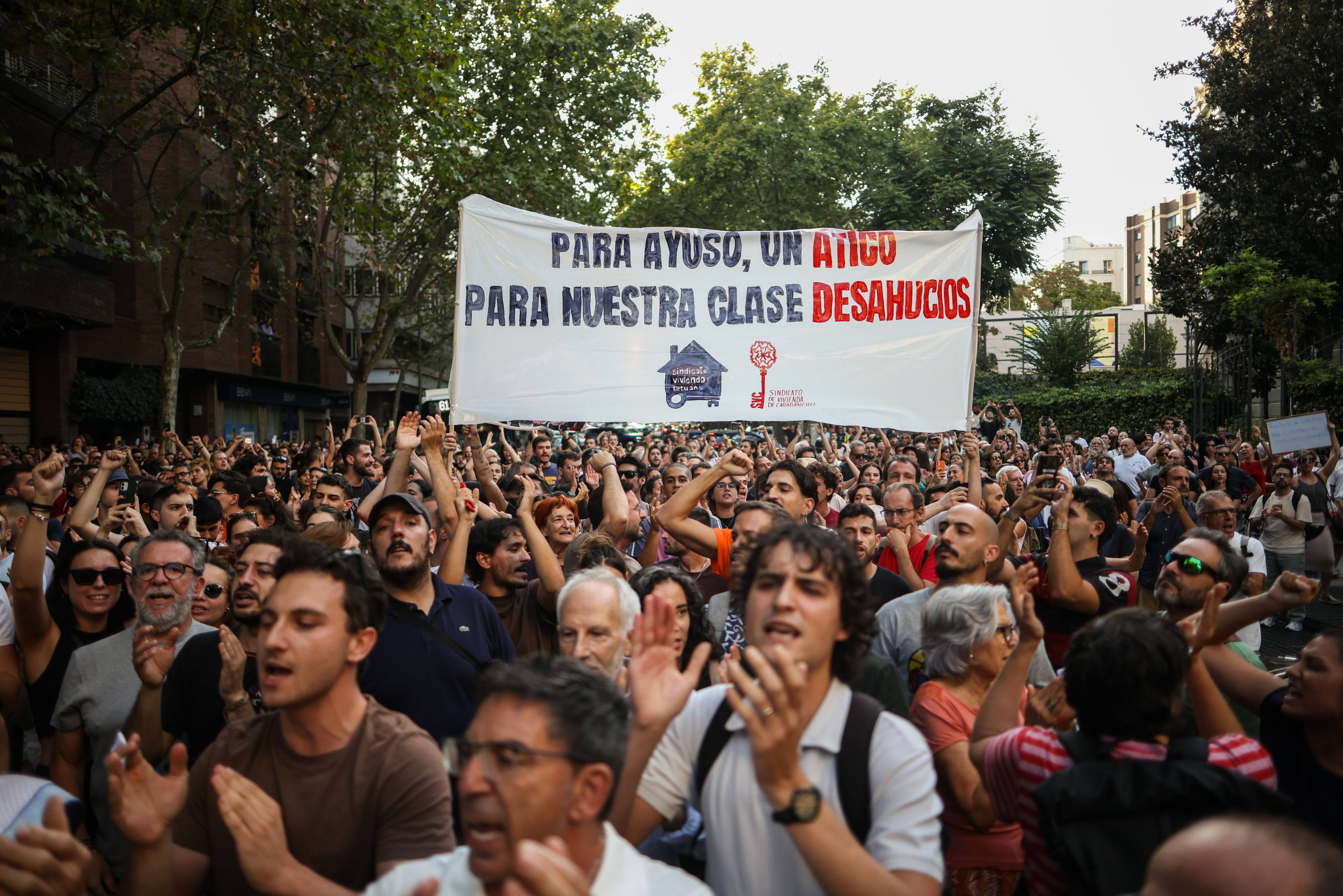 People hold a banner during a rally organised by anti-eviction campaigners in Madrid, Spain, following the eviction of 87-year-old woman Maricarmen Abascal. Photo: dpa
