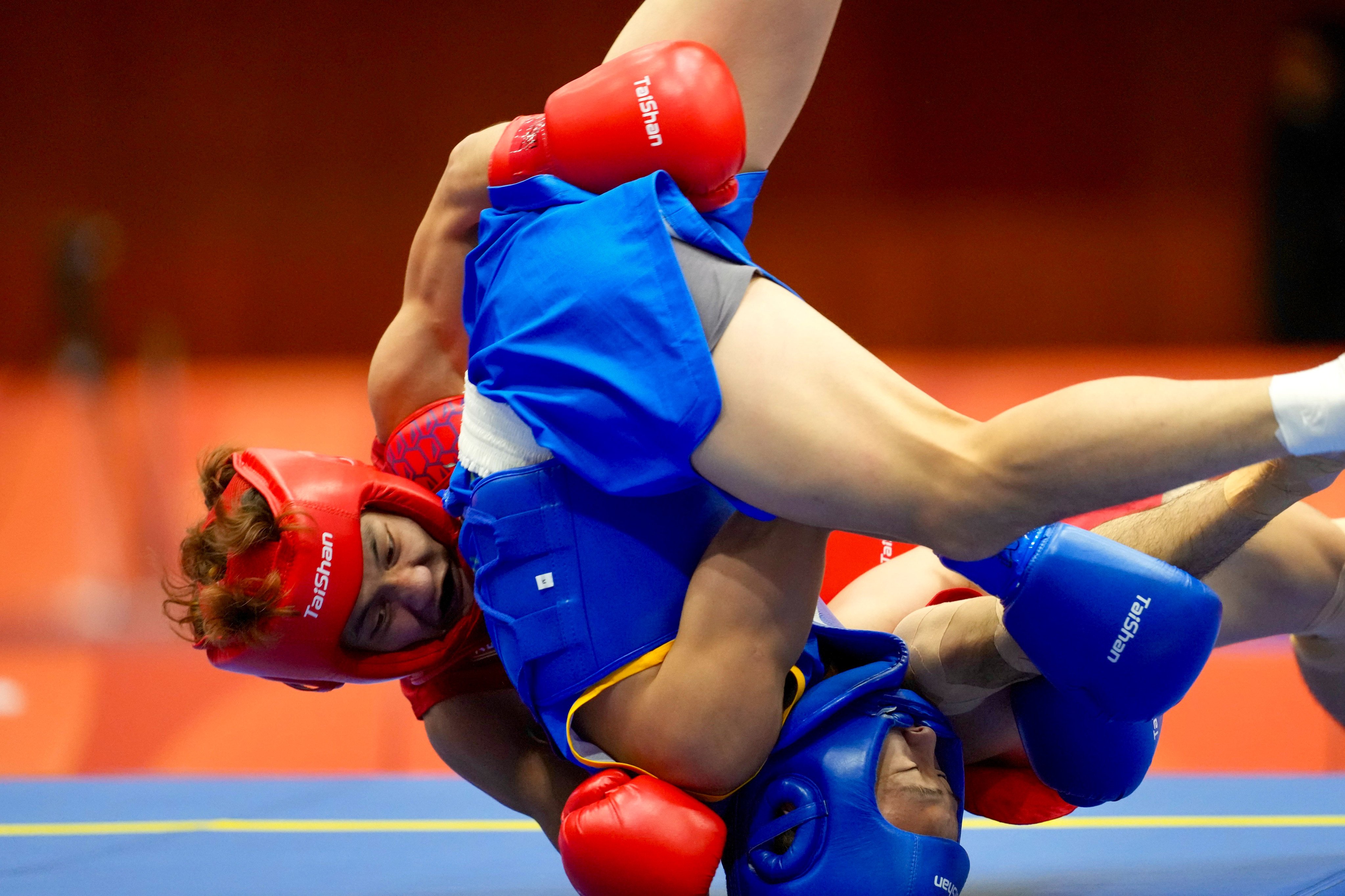 Hong Kong’s Leung Yu-hong (red) battle’s China’s Tang Sishuo during their men’s 60kg final at Aichi Prefectural Martial Arts Hall. Photo: Sam Tsang