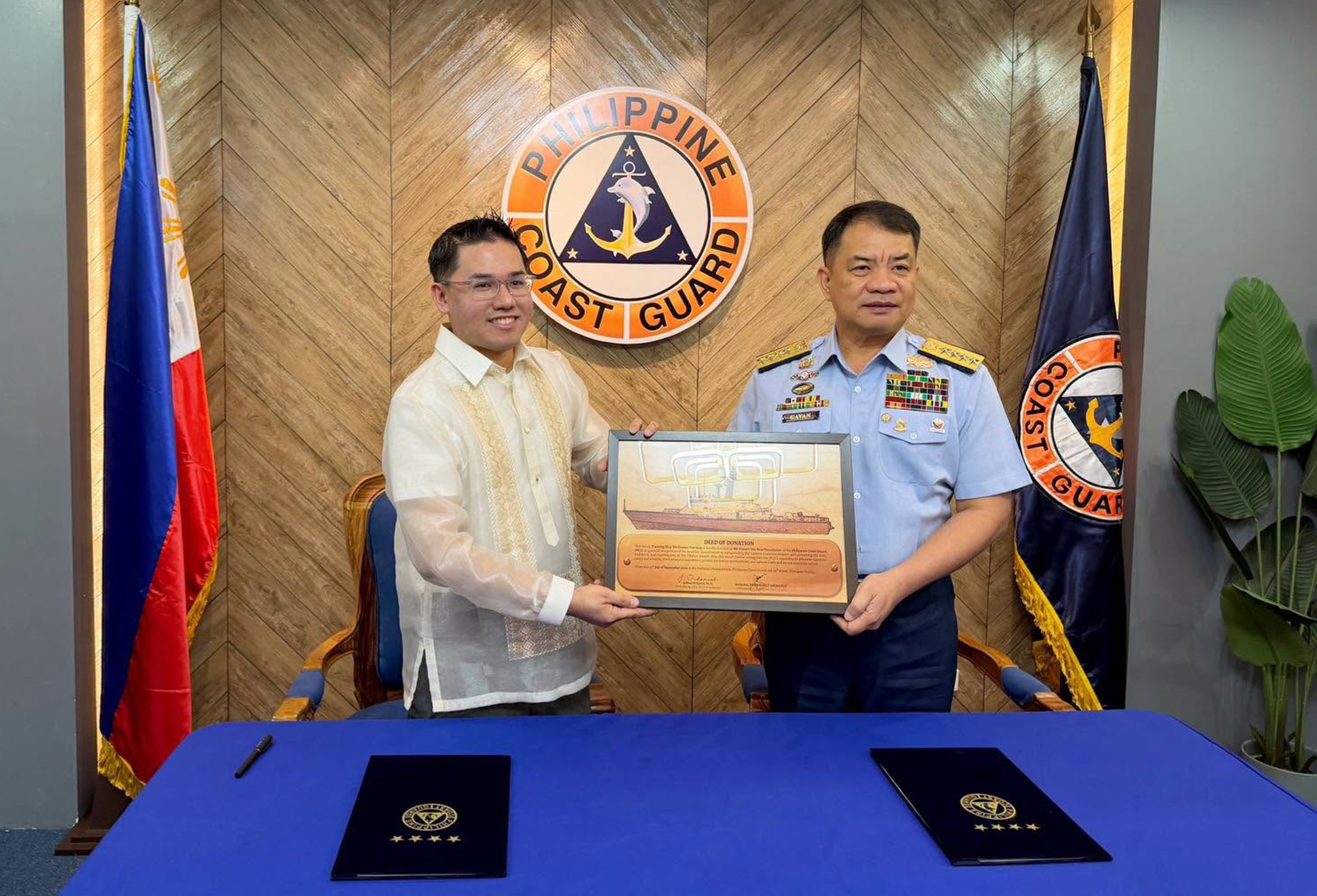 Admiral Ronnie Gil Gavan (right), commandant of the Philippine Coast Guard, receives the formal deed of donation for the 61-metre vessel from WPS Foundation CEO Jeffrey Ordaniel, in Manila on September 21. Photo: Handout