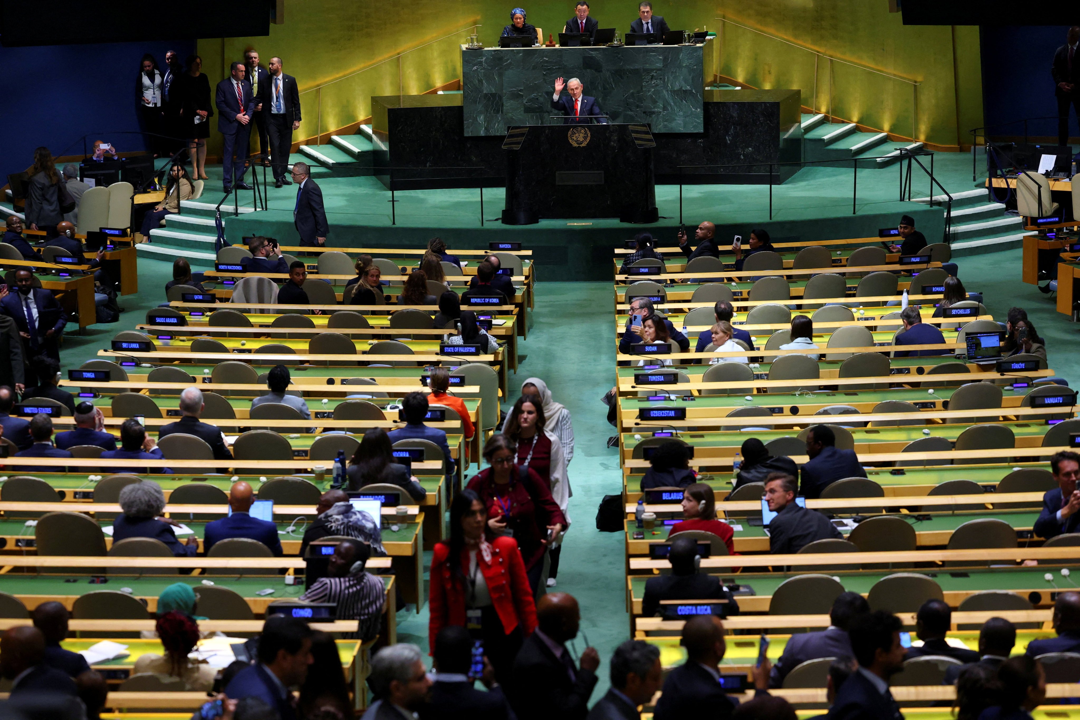 Israel’s Prime Minister Benjamin Netanyahu waves to delegates walking out. Photo: Reuters