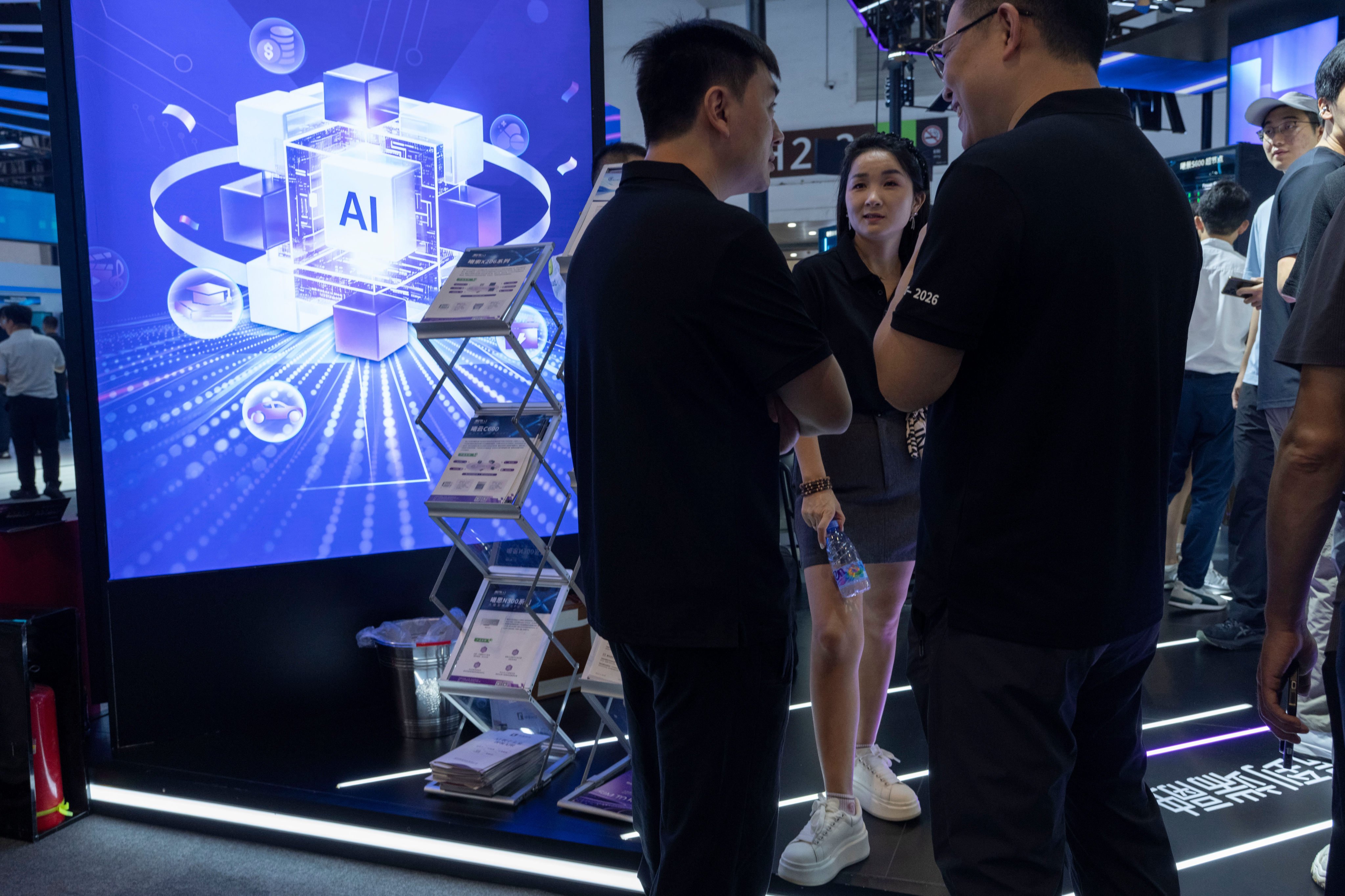 Visitors chat during the World AI Conference in Shanghai on July 17. Photo: AP