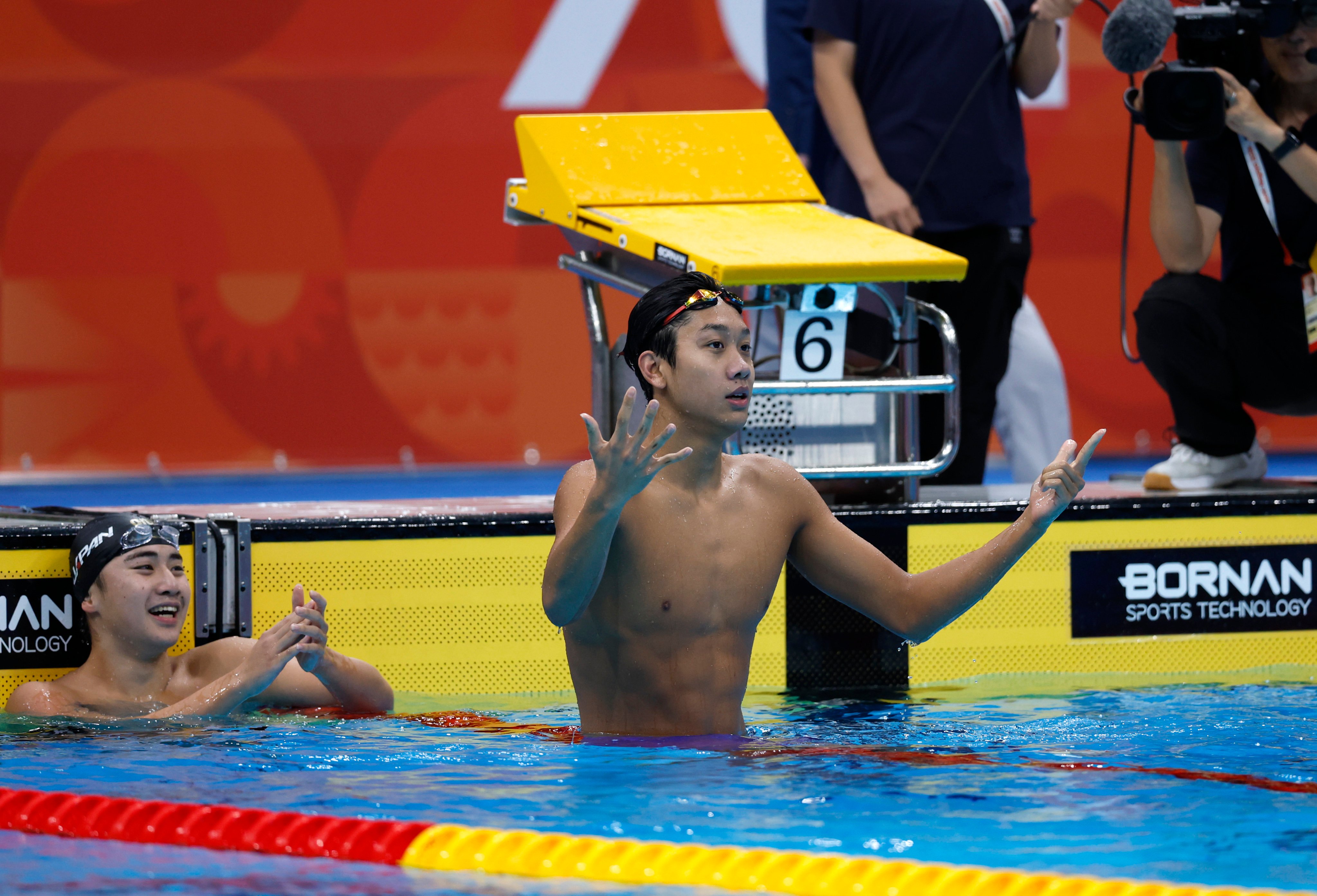 Zhang Zhanshuo of China counts his medals after winning the 400m freestyle at the Asian Games Aichi-Nagoya 2026 in Tokyo on Friday. Photo: Xinhua