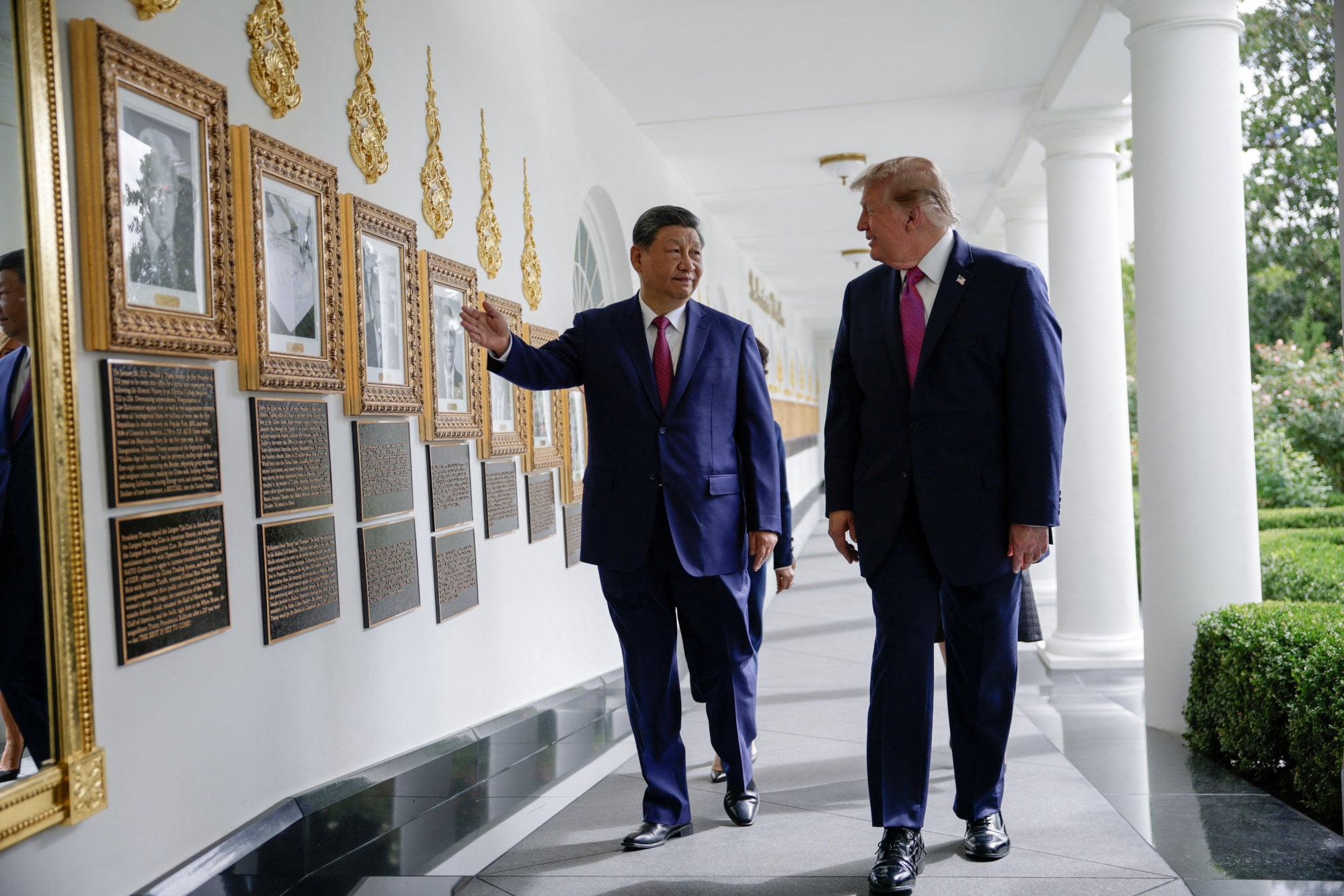 Xi and Trump walk past an image of an autopen signing former president Joe Biden’s signature at the White House’s Presidential Walk of Fame on Thursday. Photo: Reuters