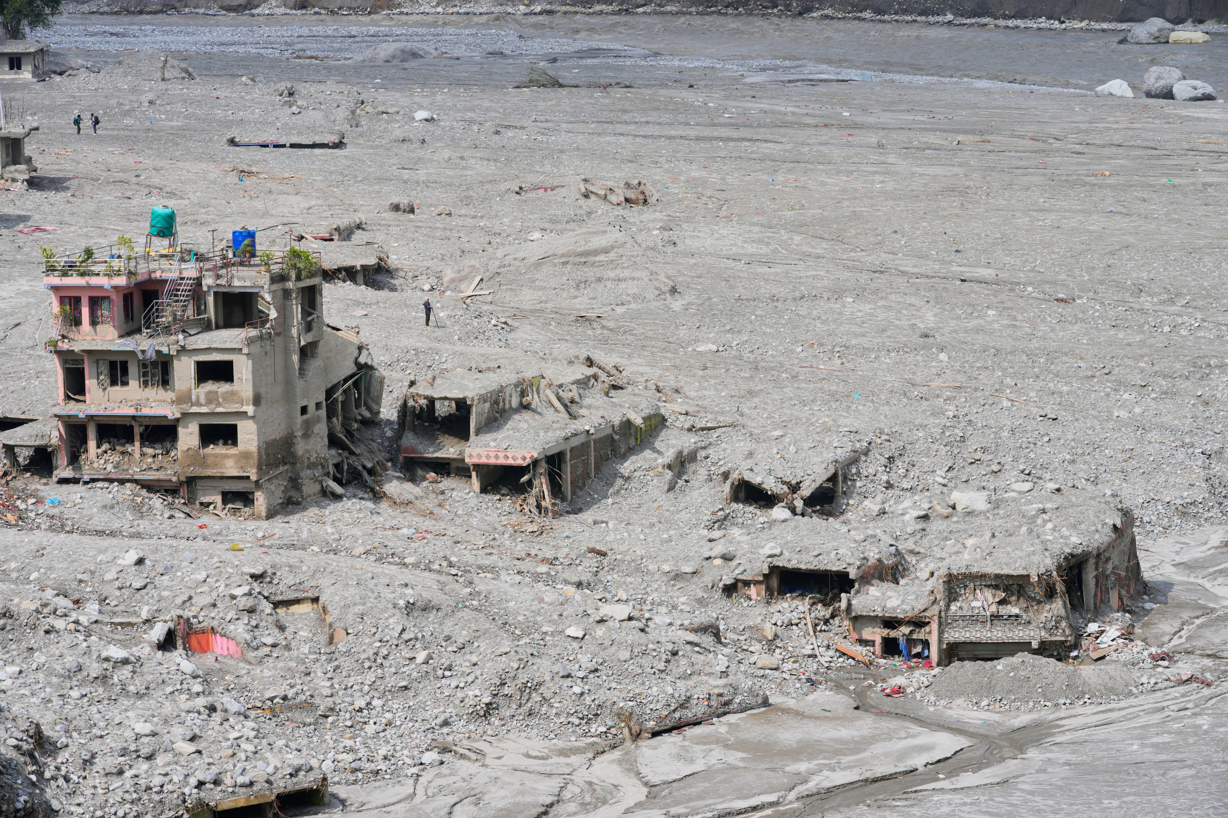 Houses damaged by recent flash floods stand amid thick layers of sludge, mud and debris in Nepal’s Nuwakot district on September 8. Photo: AP