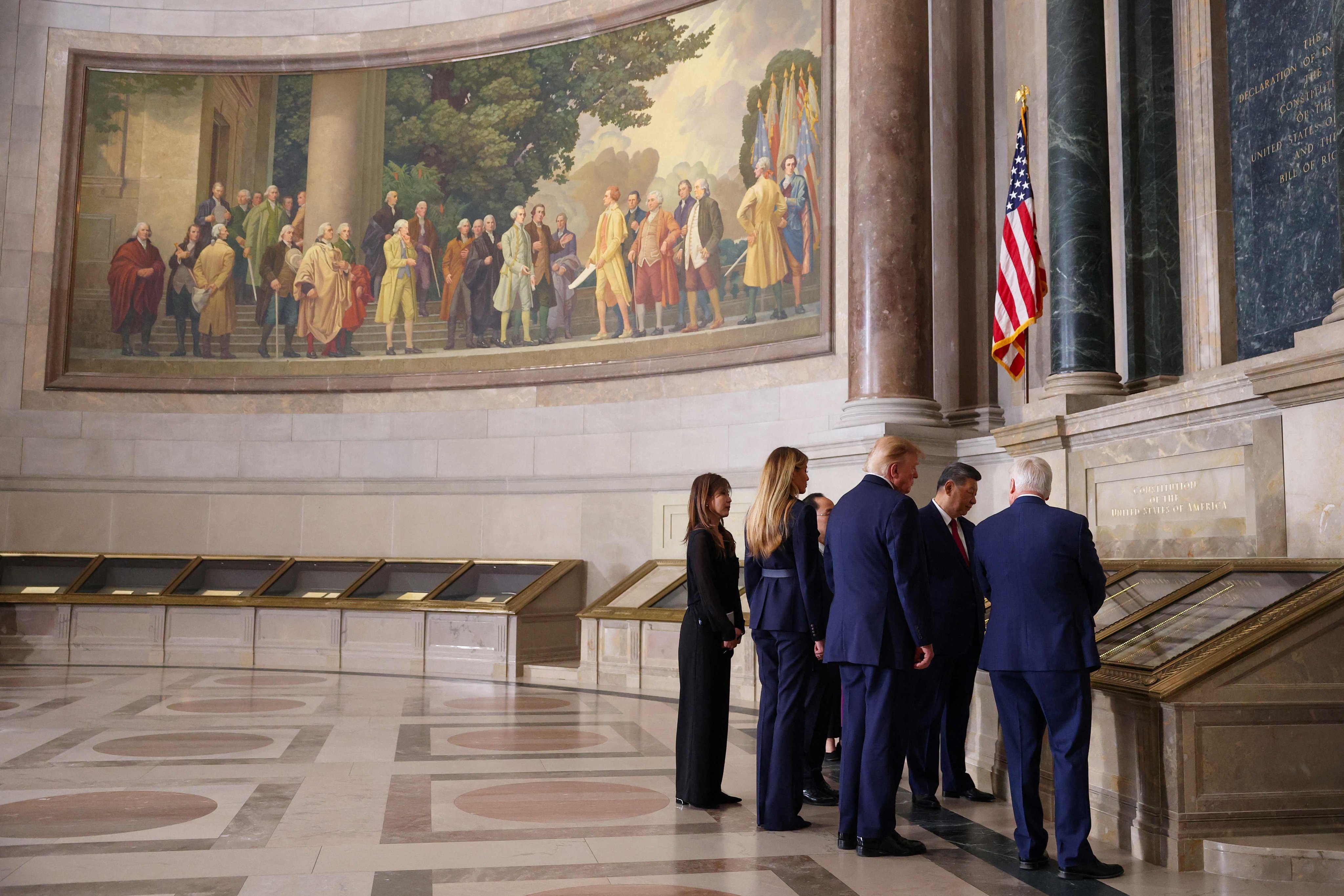 The presidential party view the US Constitution during a tour of the National Archives Museum. Photo: Getty Images/AFP