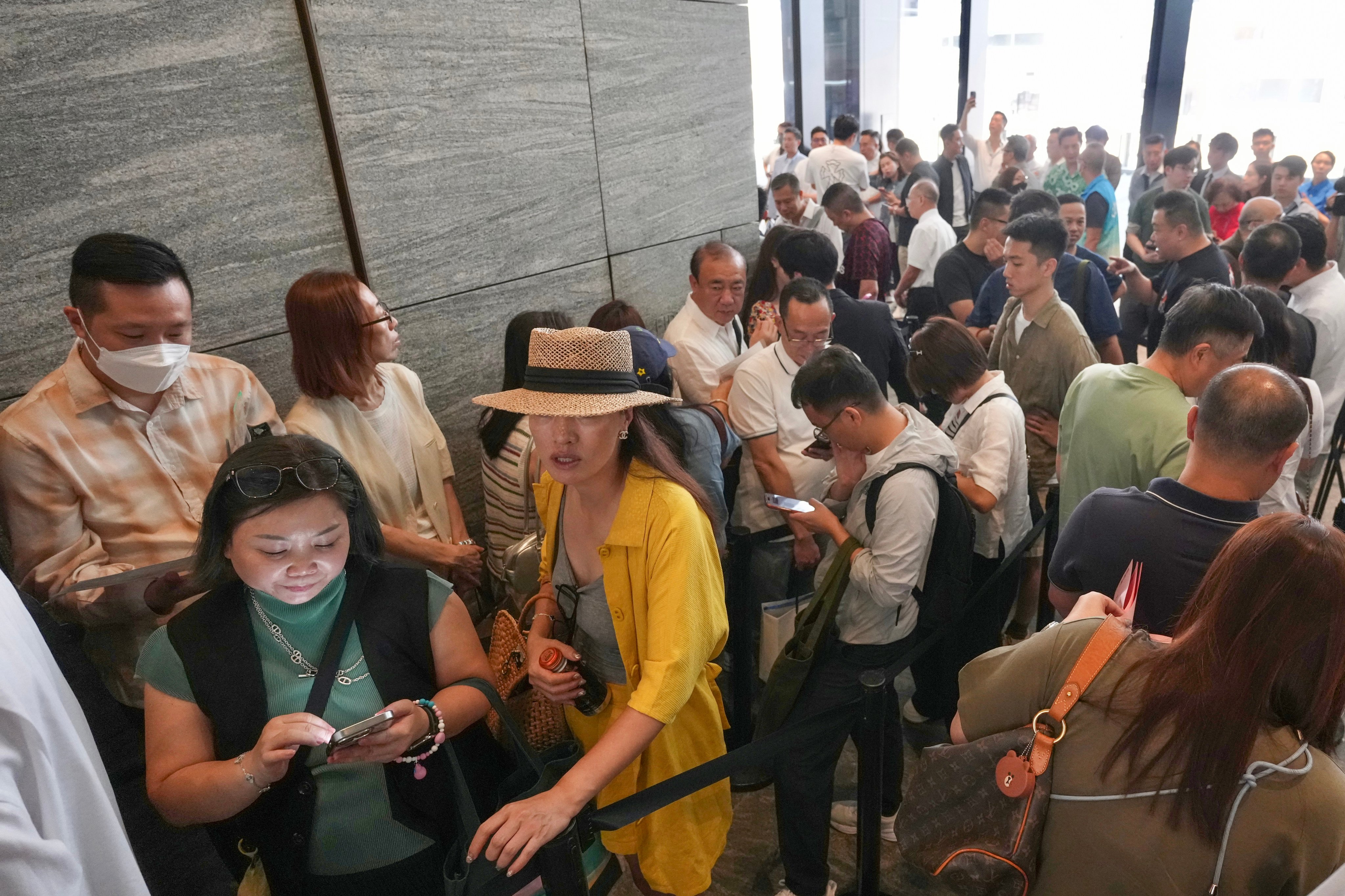 People queue at a sales centre in Quarry Bay to buy flats at the new State Residence project in North Point on Saturday. Photo: Karma Lo