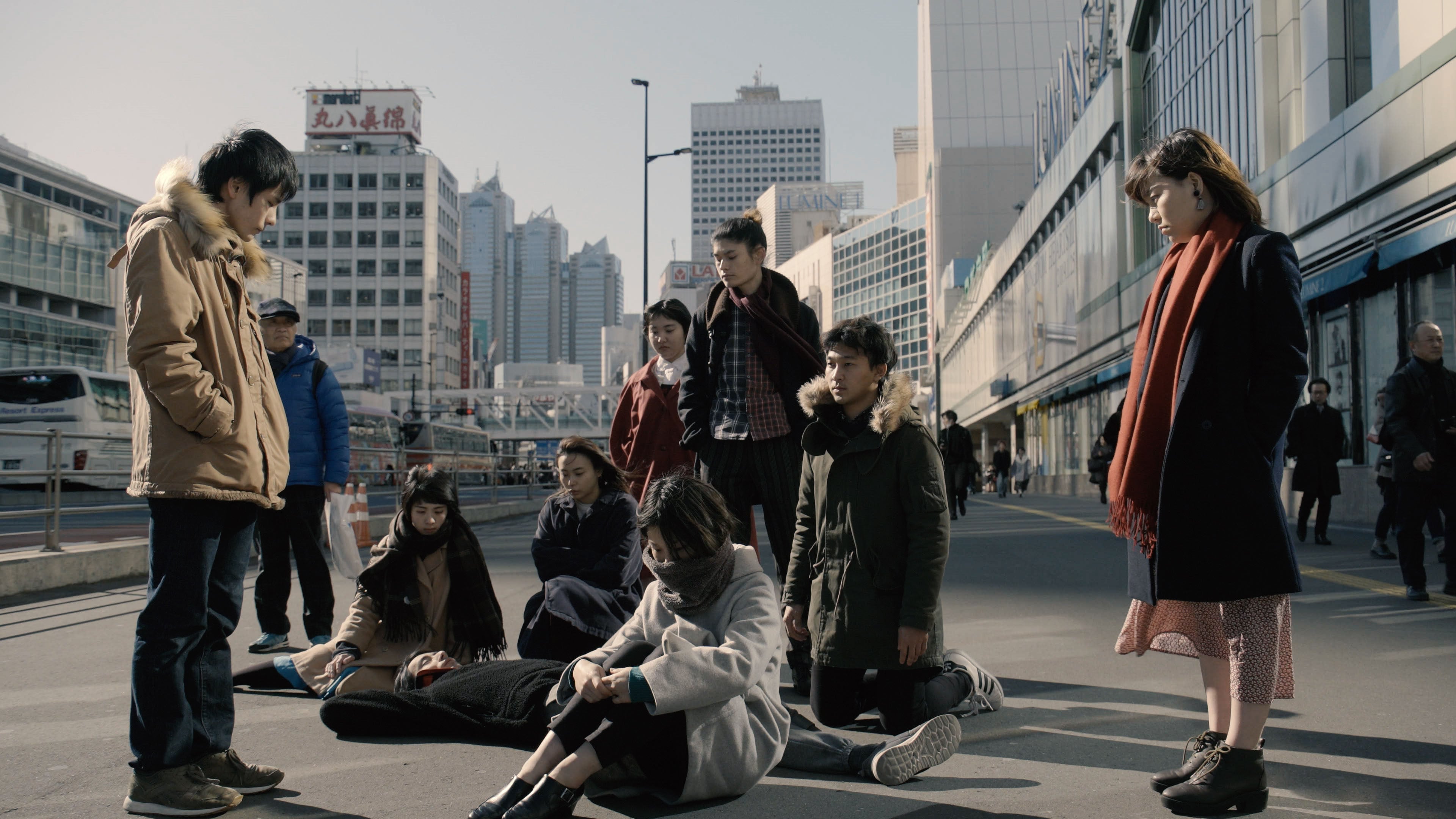 Young people recite Hajime Kondo’s testimony on the streets of Tokyo in a video installation by Meiro Koizumi. Photo: Meiro Koizumi/Kyodo