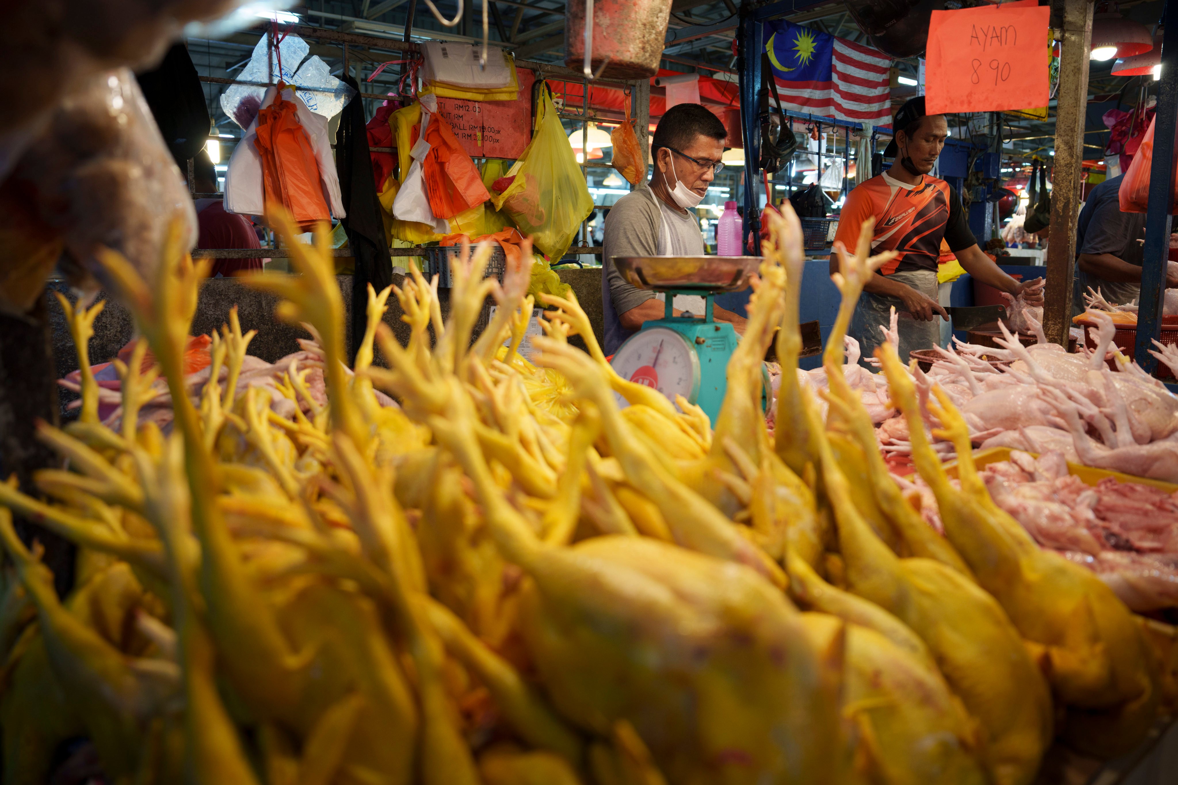 A seller prepares freshly butchered chickens at a wet market in Kuala Lumpur. Photo: AP