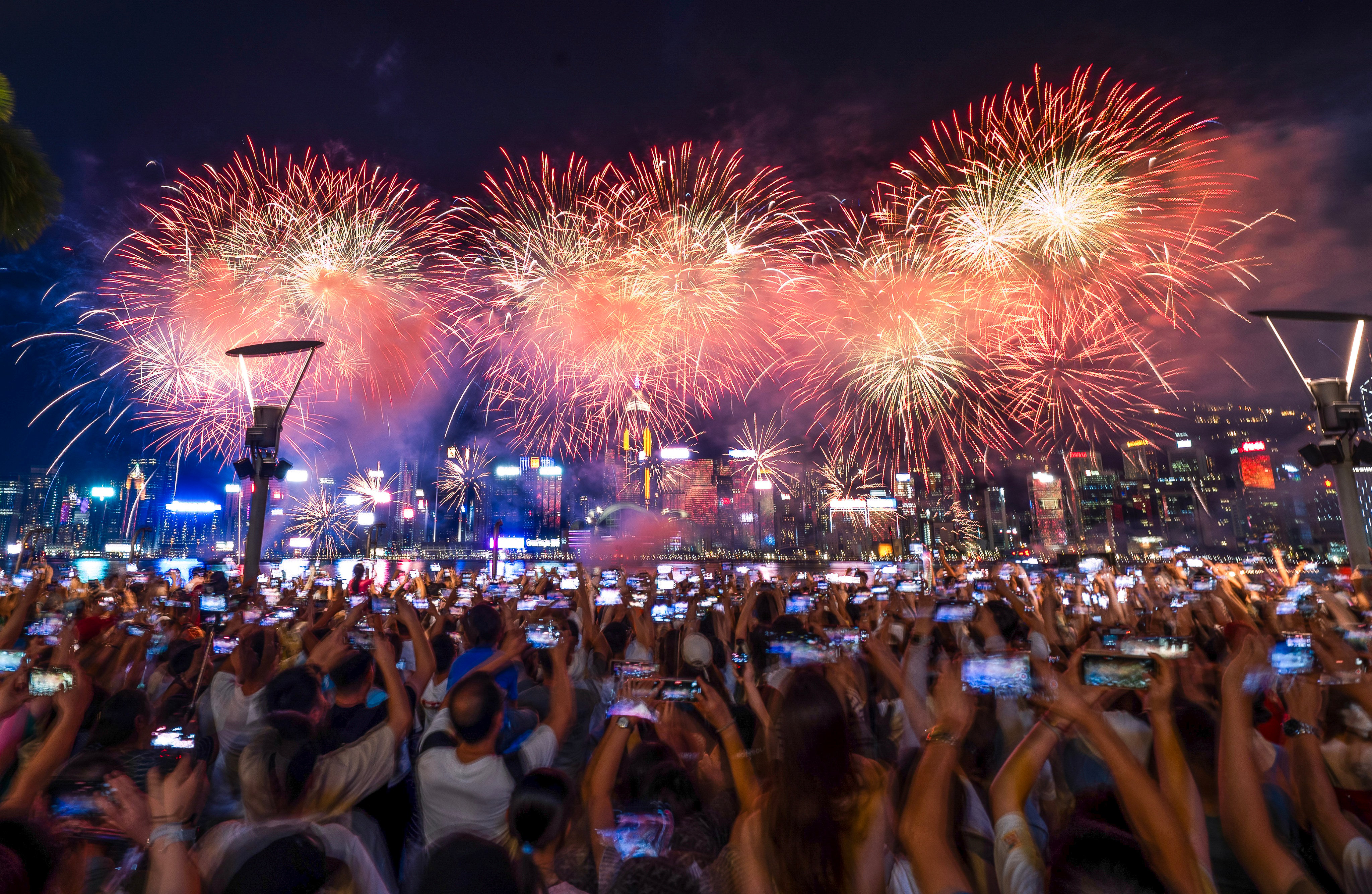 People gather at the Tsim Sha Tsui waterfront to watch the National Day fireworks show last year. Photo: Elson Li