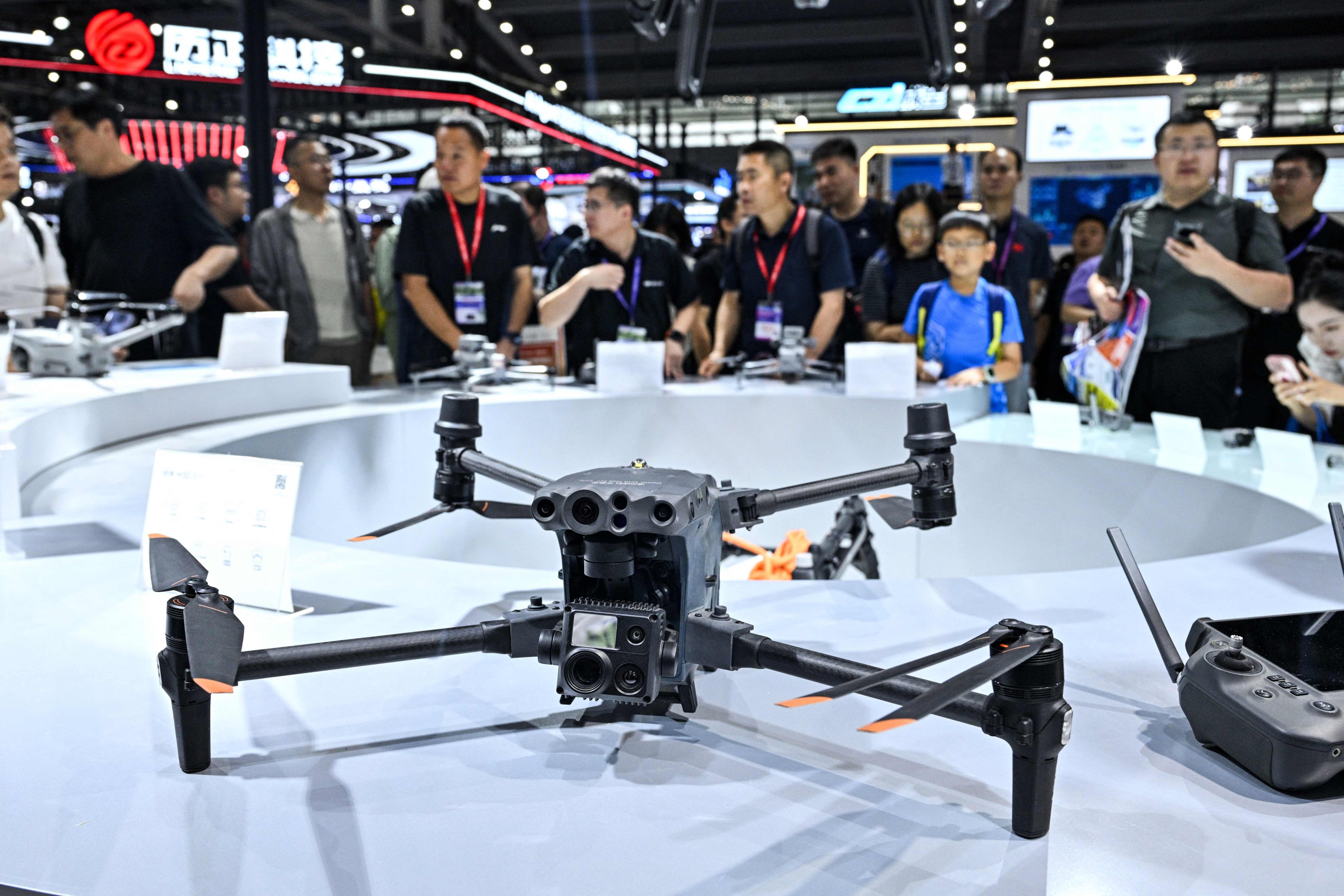 Visitors are seen at the DJI stand during the Drone World Congress in China’s Shenzhen on May 21. Photo: AFP